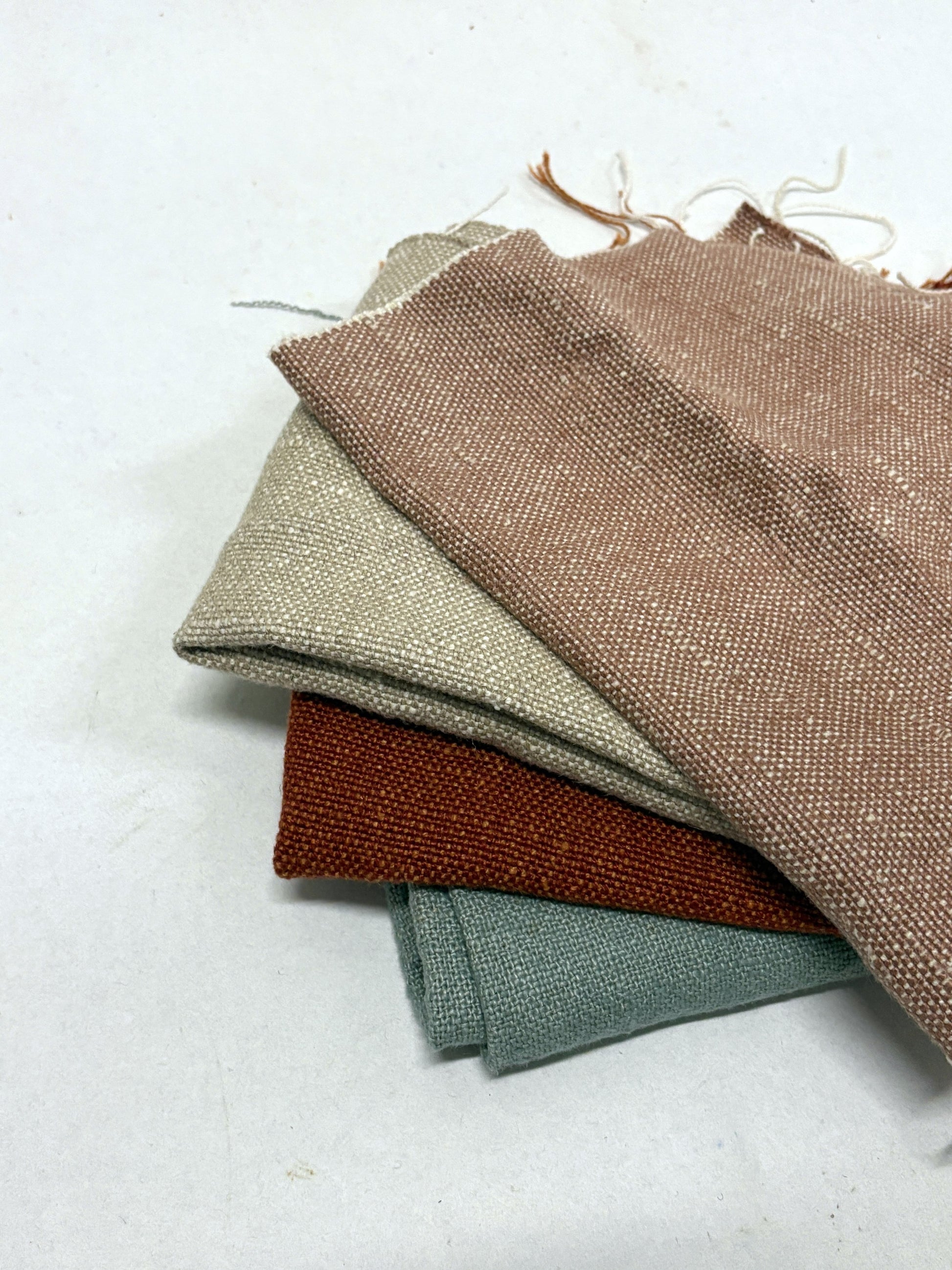 Stack of linen fabric swatches in various colours 