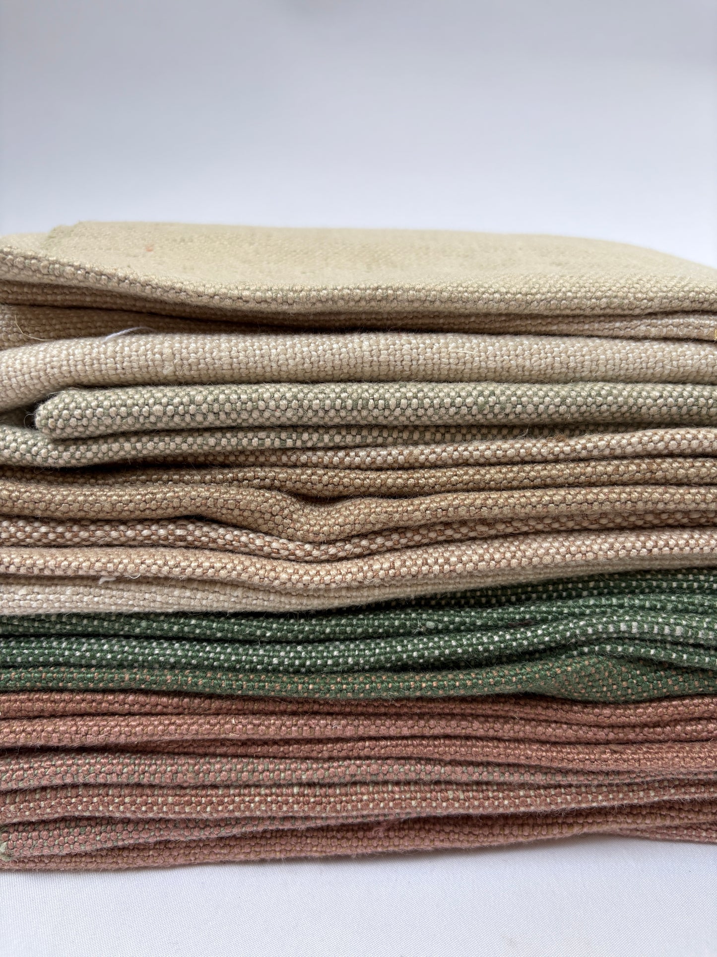 Stack of linen fabric swatches in various colours 