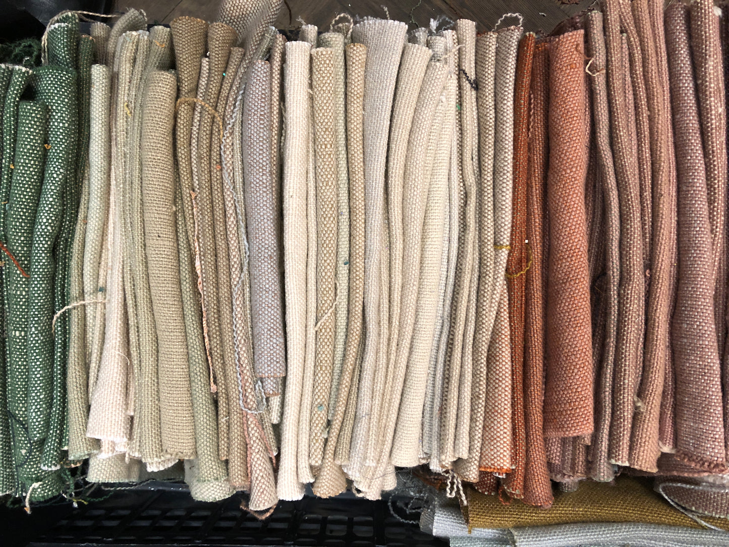 Stack of linen fabric swatches in various colours 