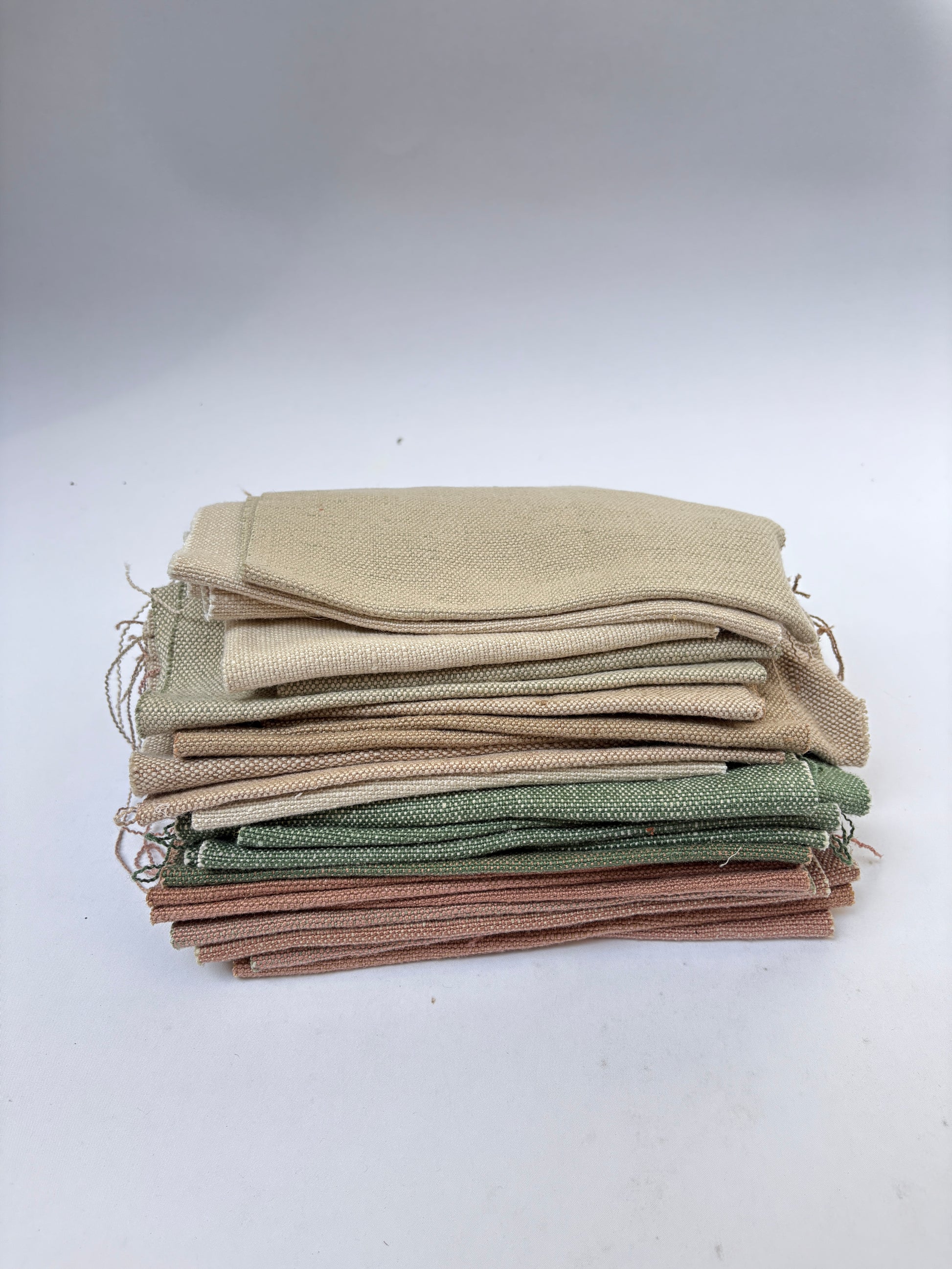 Stack of linen fabric swatches in various colours 