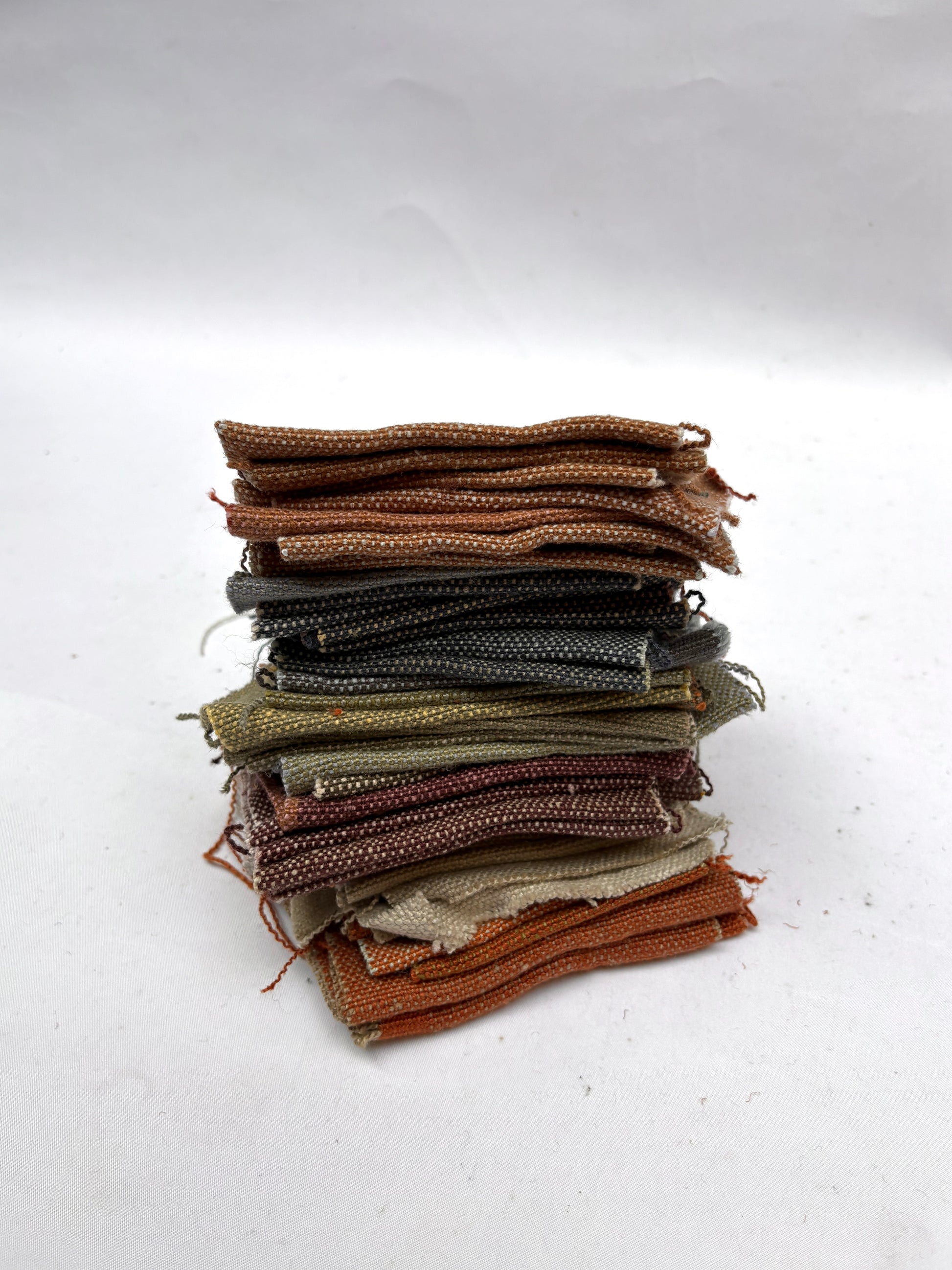 Stack of linen fabric swatches in various colours 