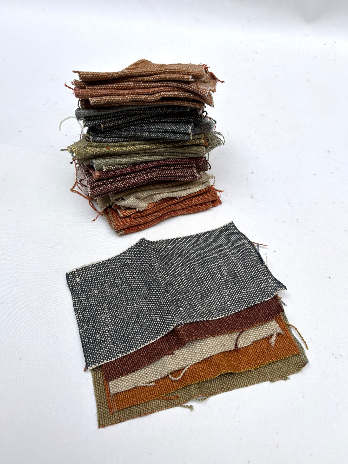 Stack of linen fabric swatches in various colours 