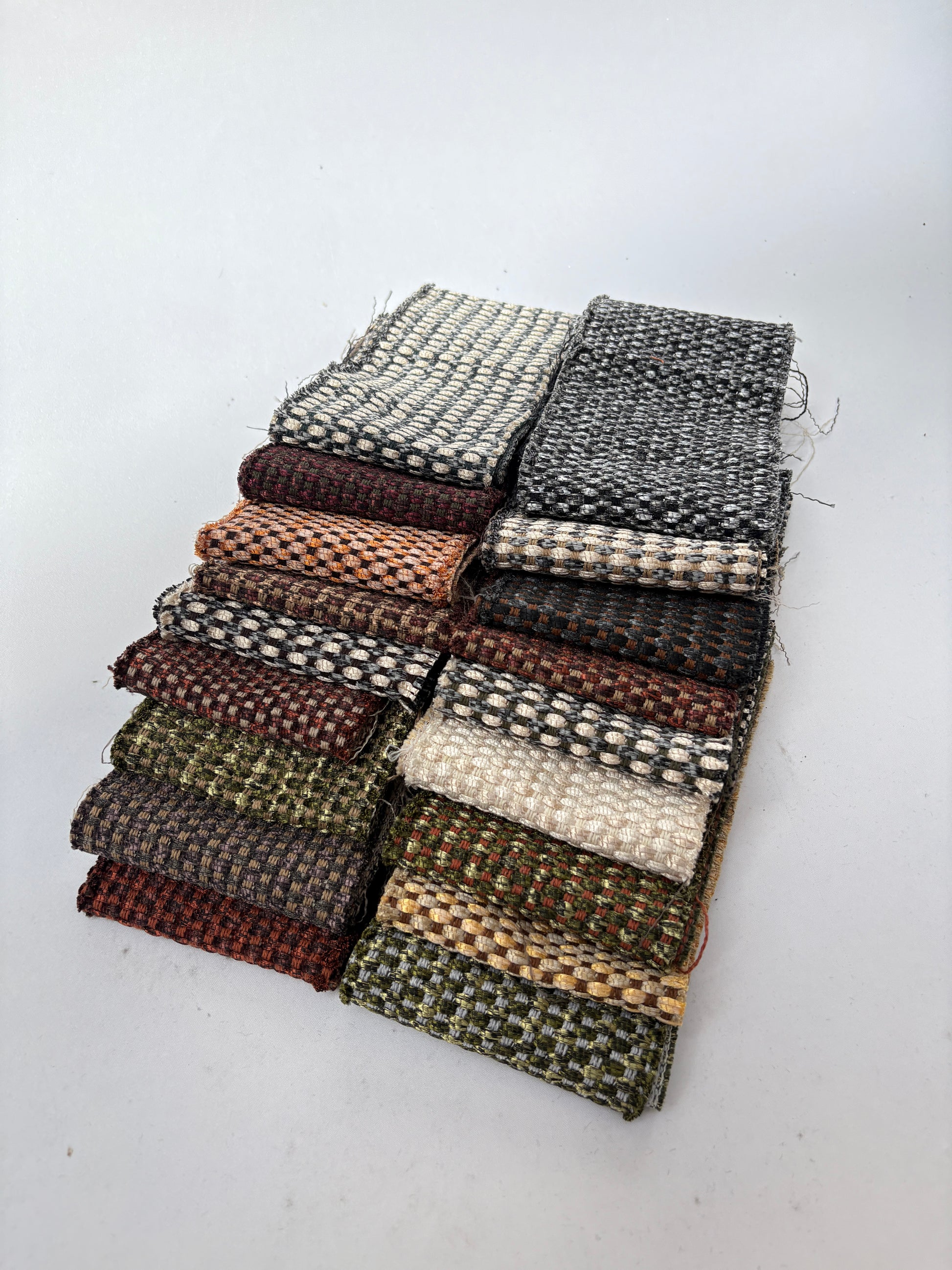 Long patterned fabric offcuts with textured shimmer finish on a white background.