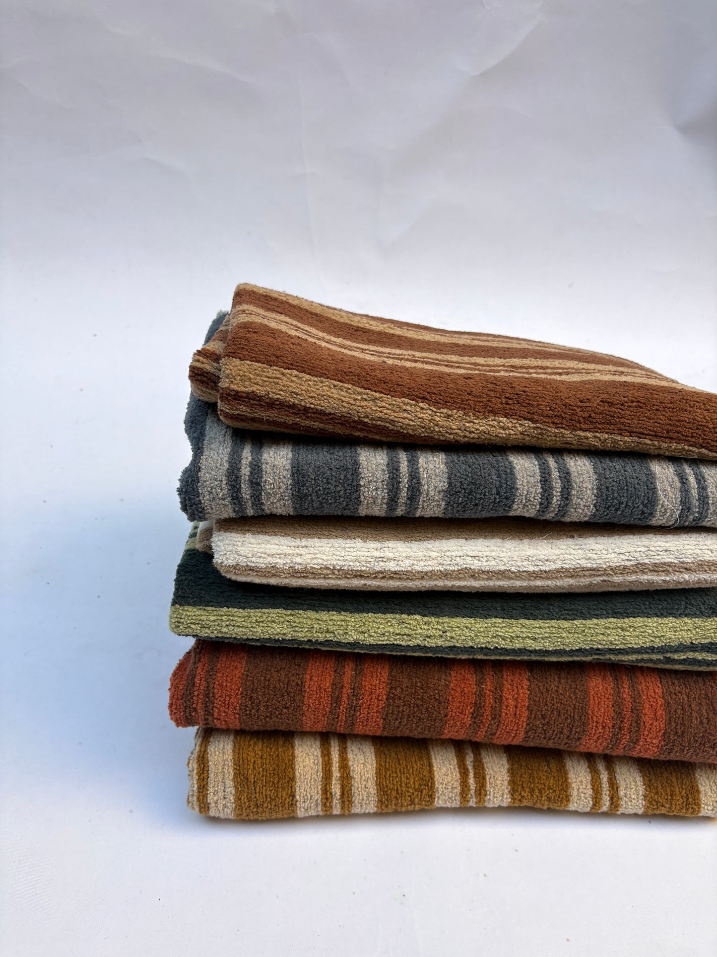Stack of striped patterned fabric in various colours