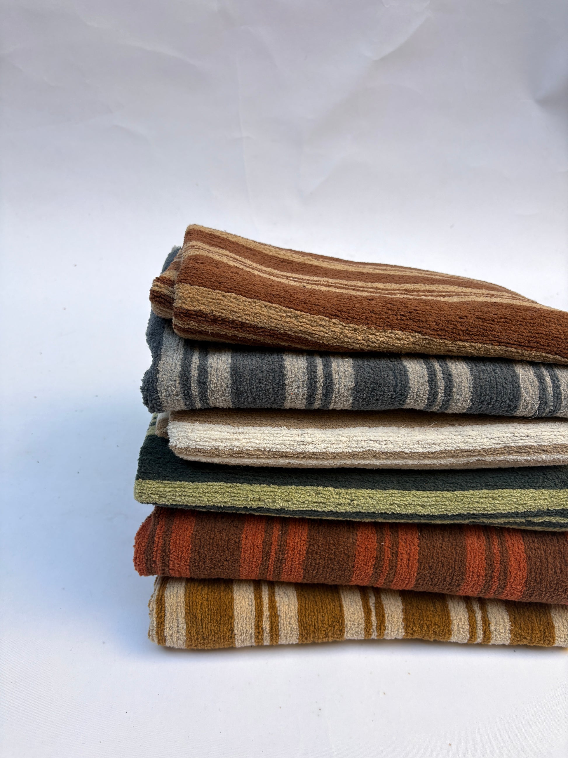 Stack of striped patterned fabric in various colours