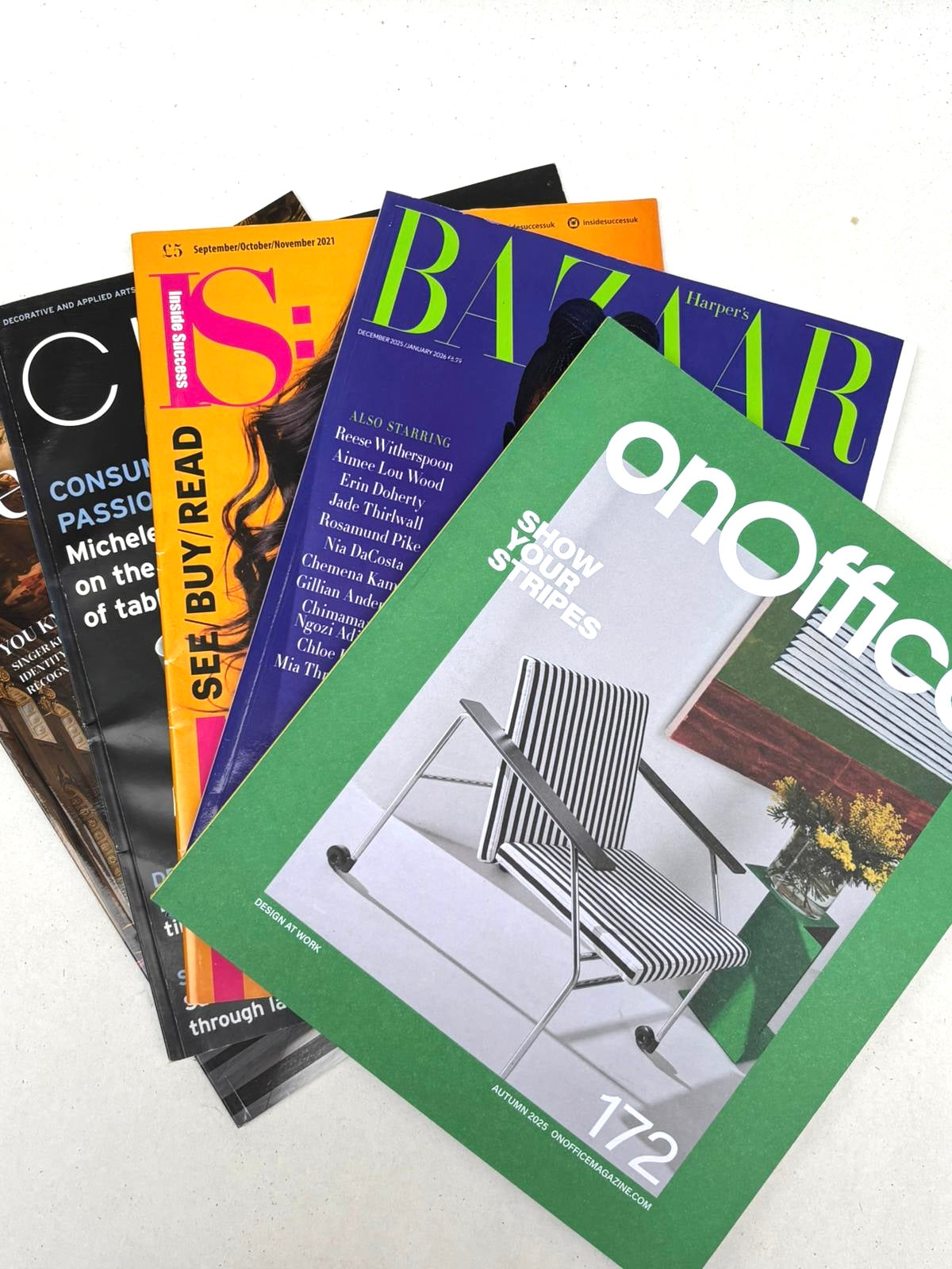 A mixed bundle of magazines stacked on a white background.