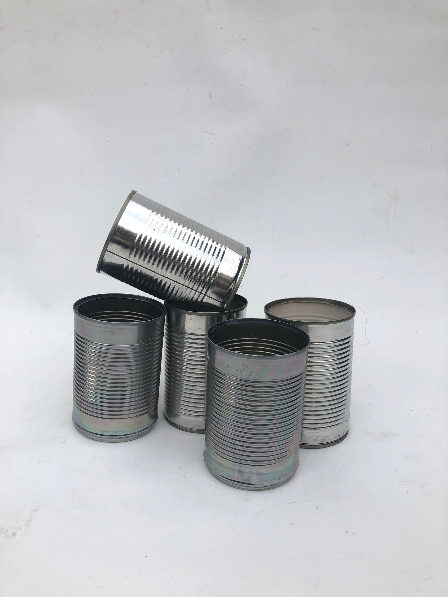 five empty metal cans 