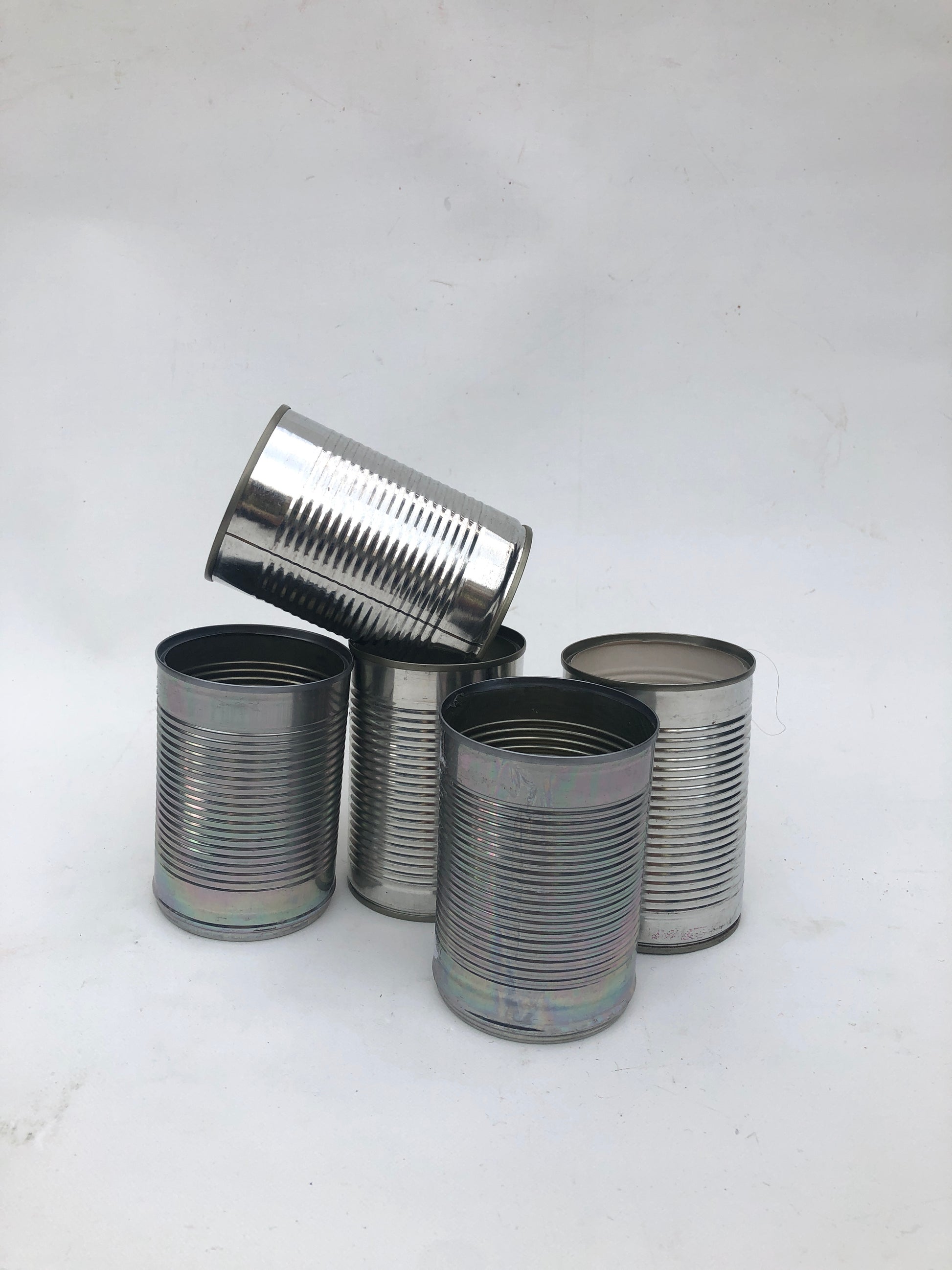 five empty metal cans 
