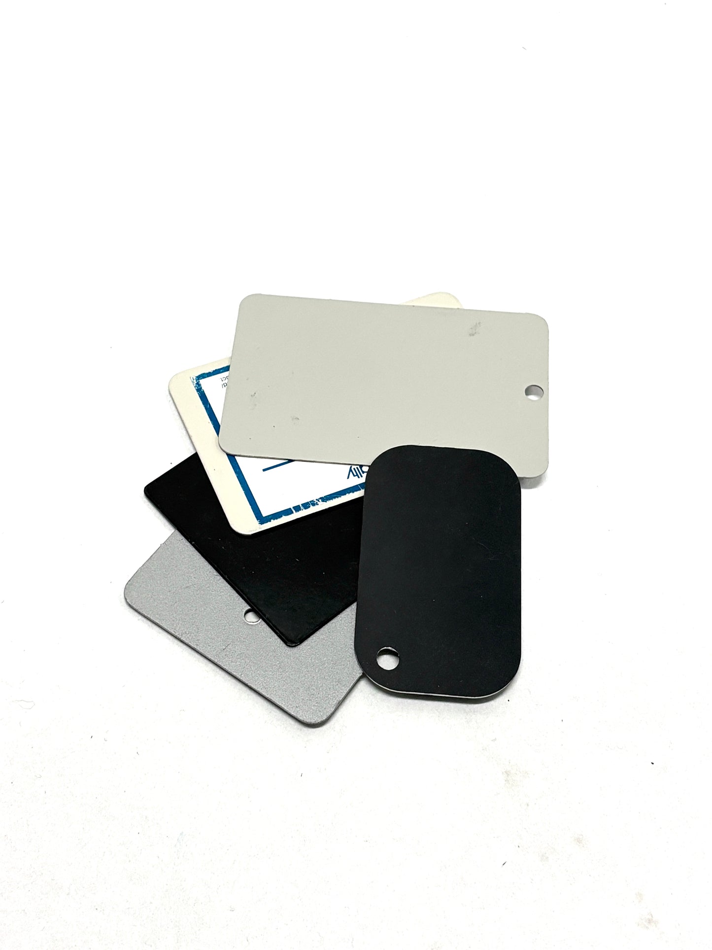 Rectangular metal samples with white, black, and silver 