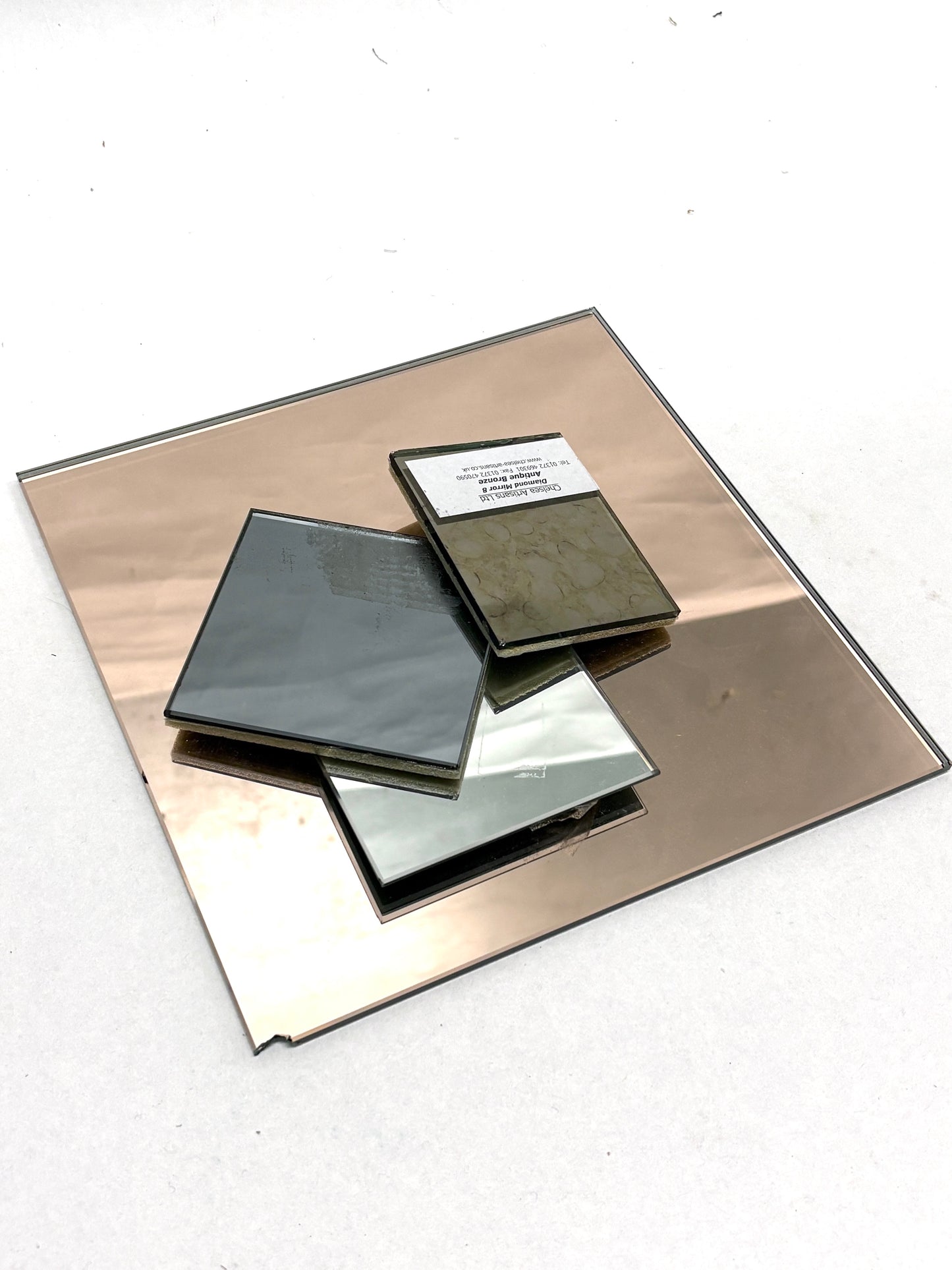 Four pieces of various coloured, sized mirror samples
