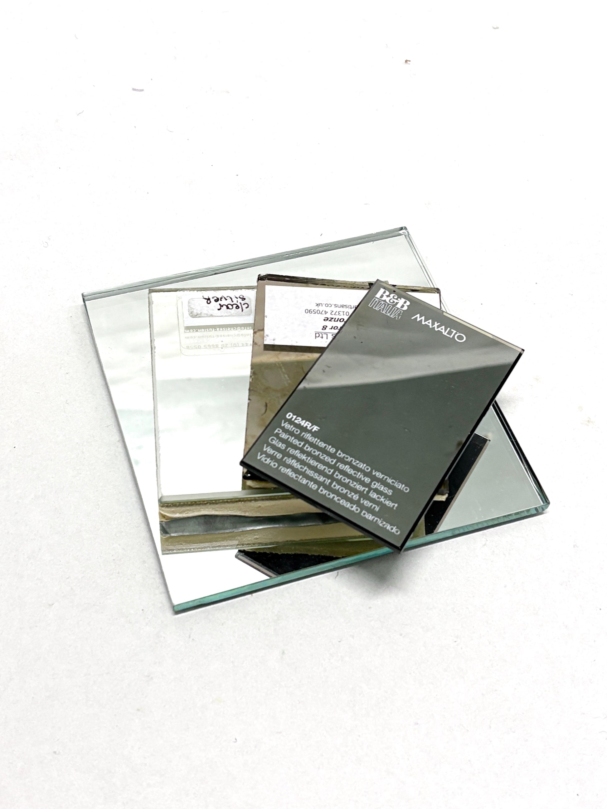 Four pieces of various coloured mirror samples