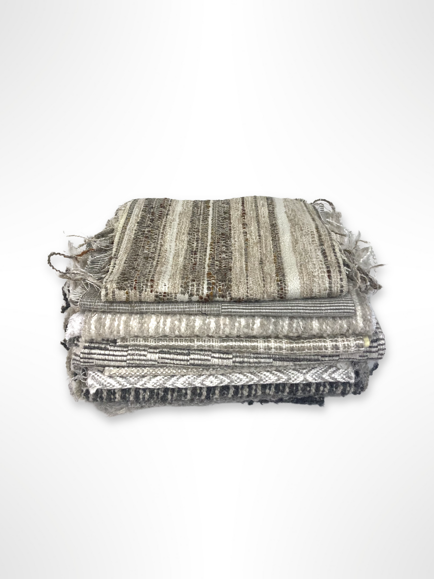 Stack of neutral coloured heavyweight fabrics