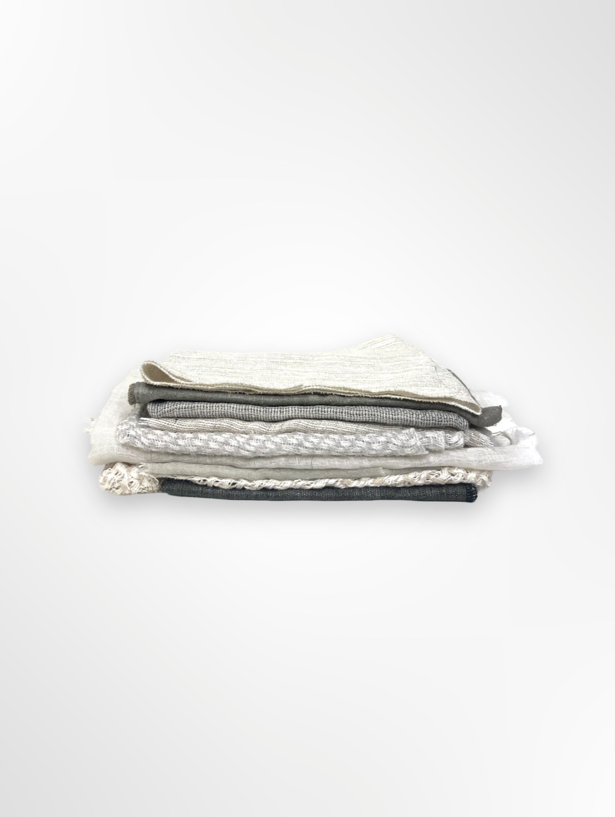 A stack of various sized neutral coloured lightweight fabric
