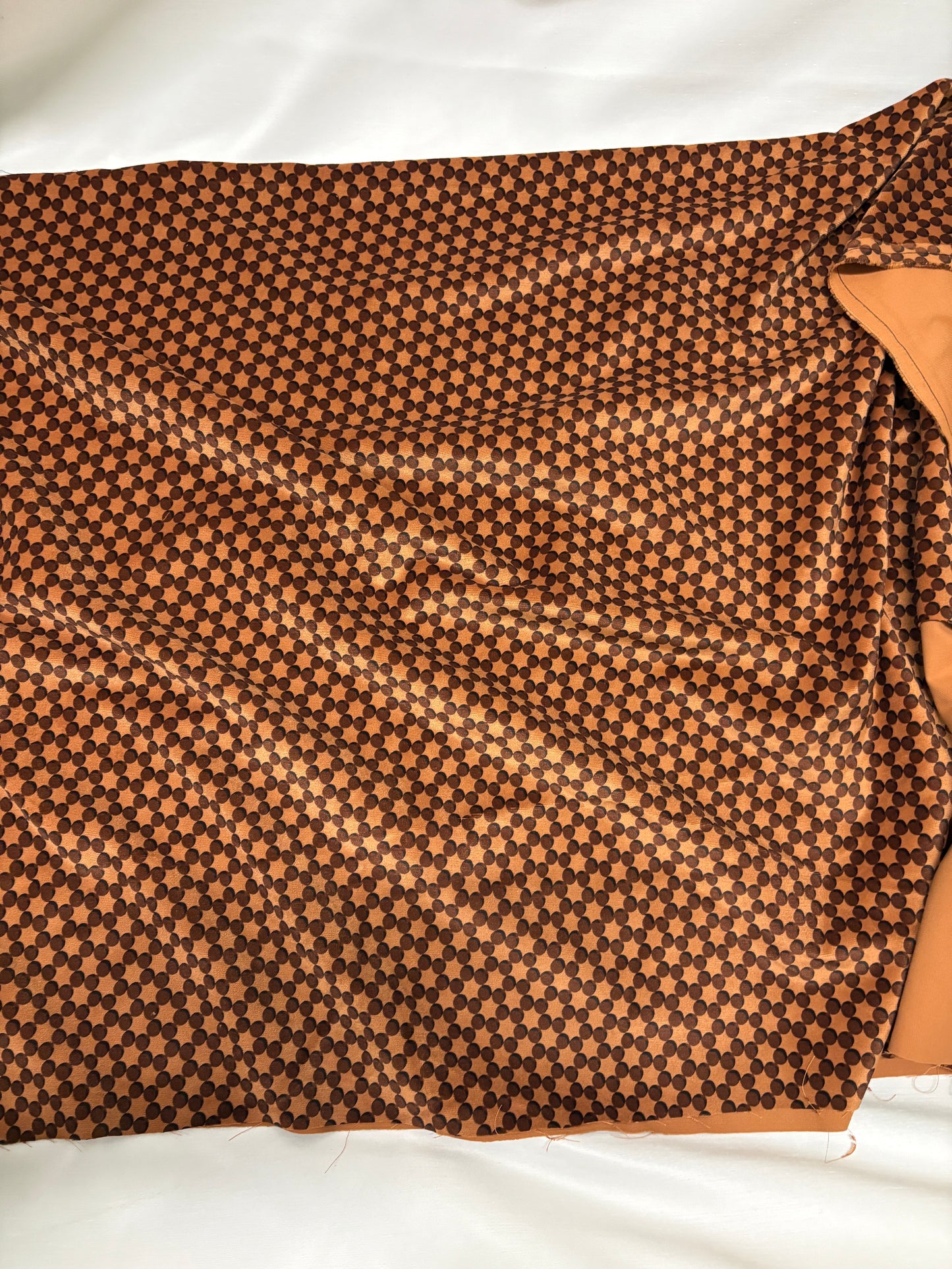 Orange dot patterned velvet fabric, texture visible