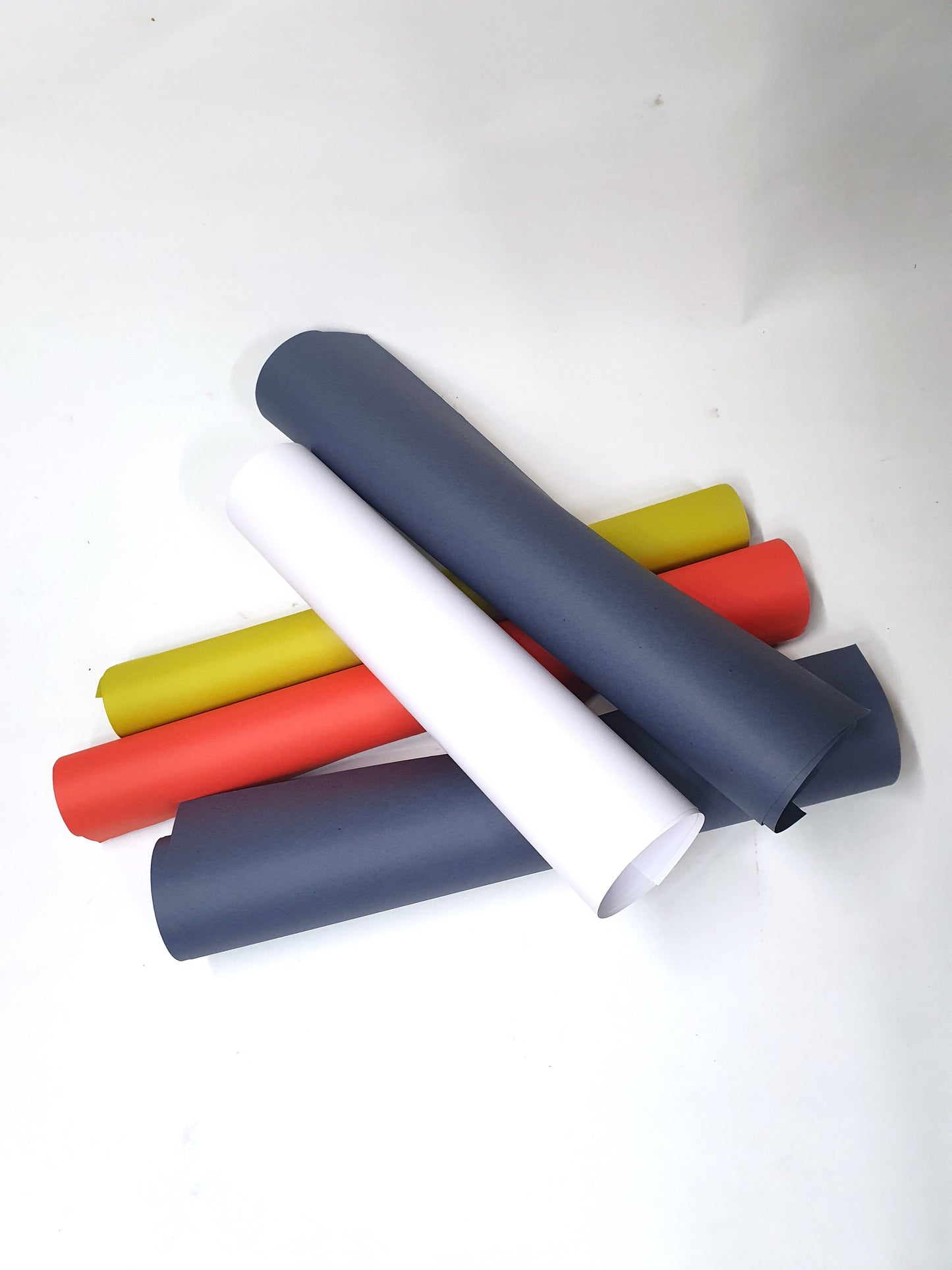 A collection of rolled coloured papers