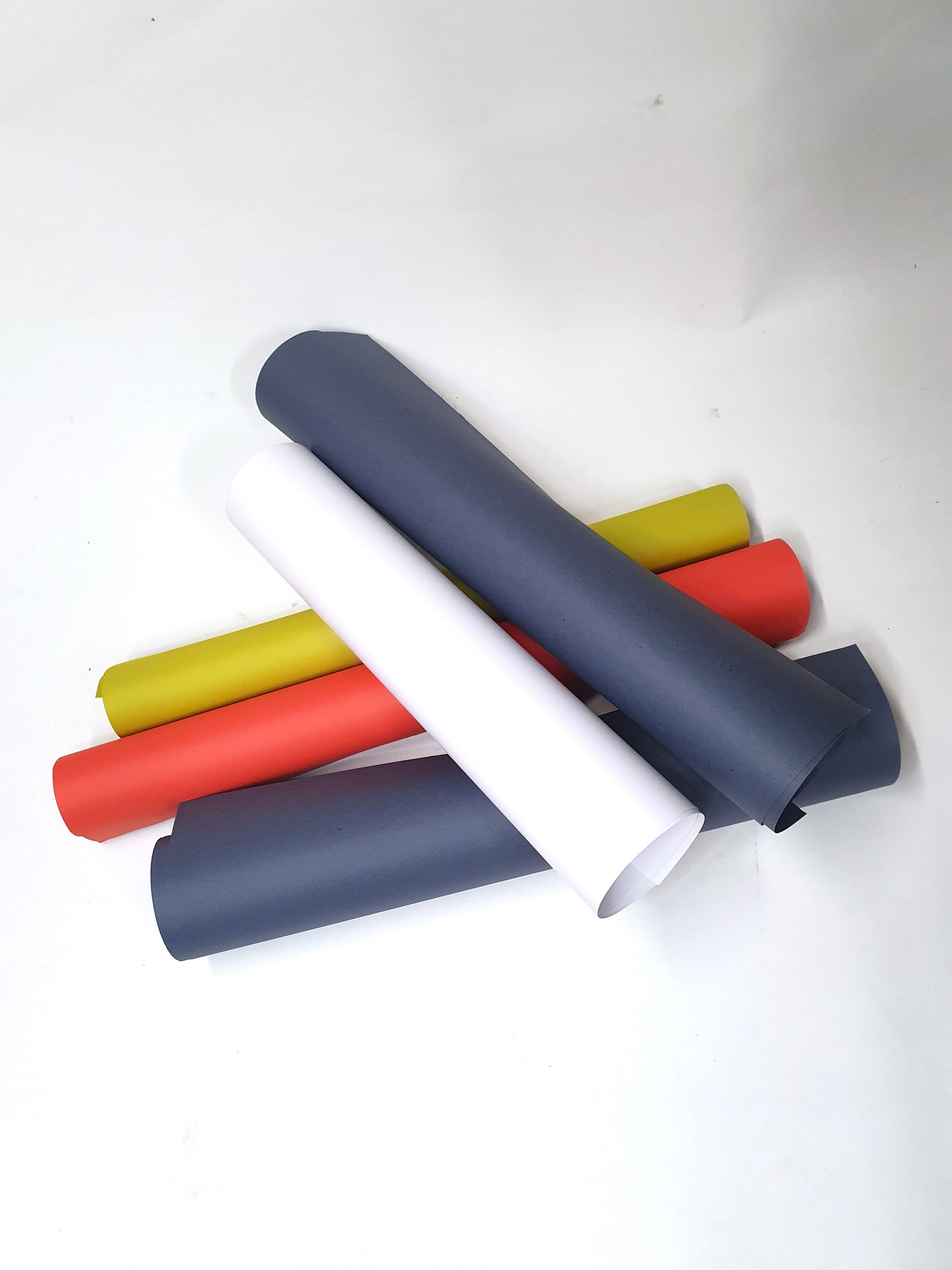 A collection of rolled coloured papers