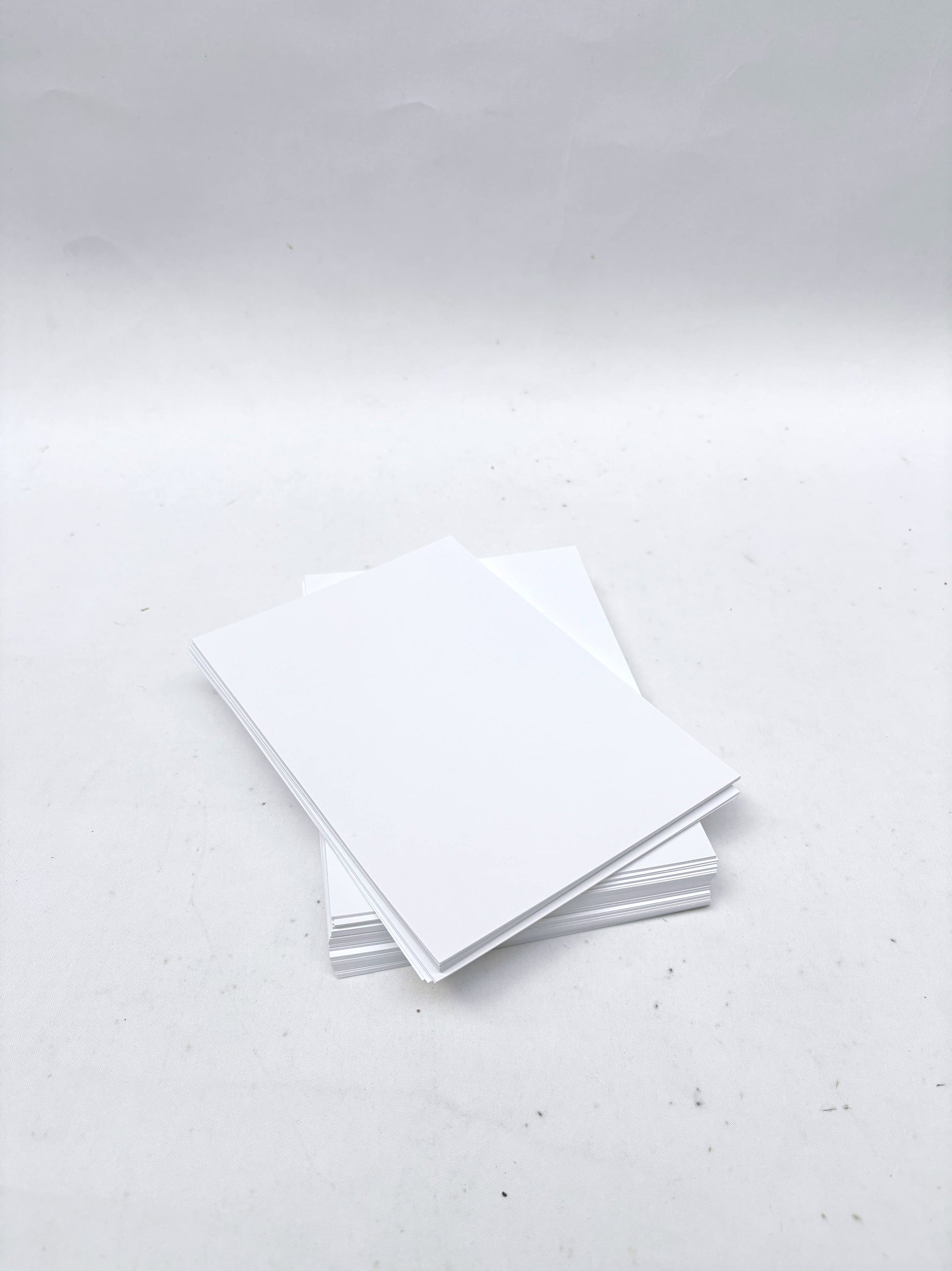 A stack of rectangular white paper
