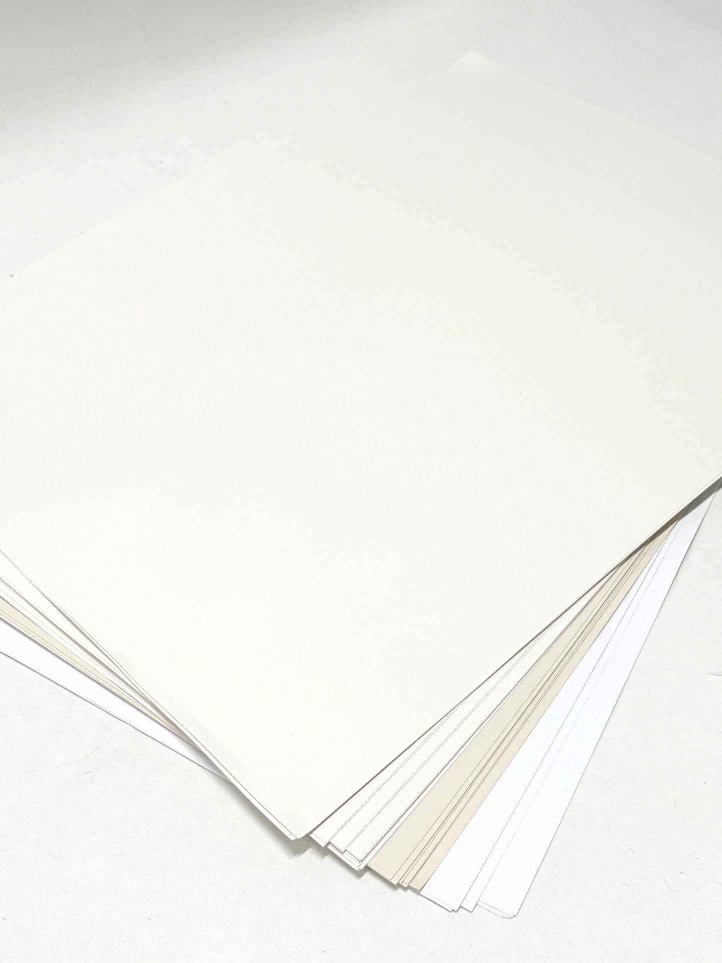 A stack of paper with various types of whites 