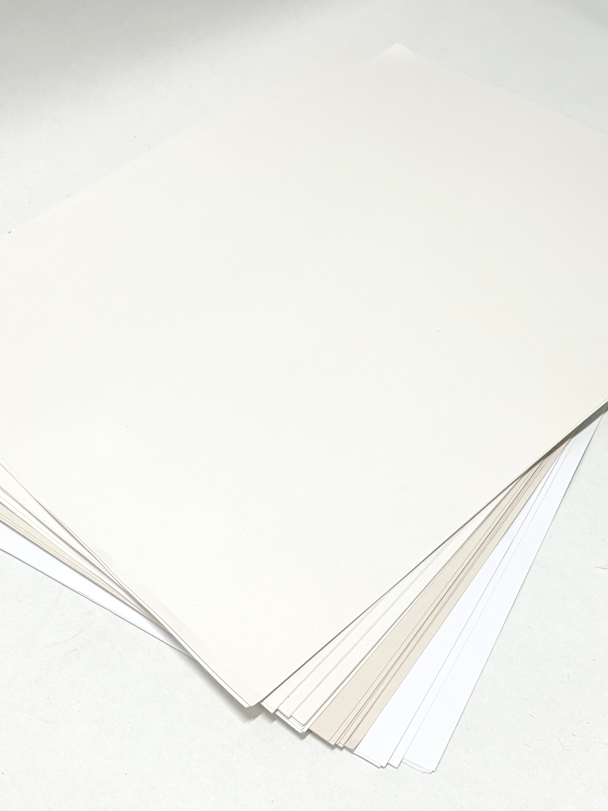 A stack of paper with various types of whites 