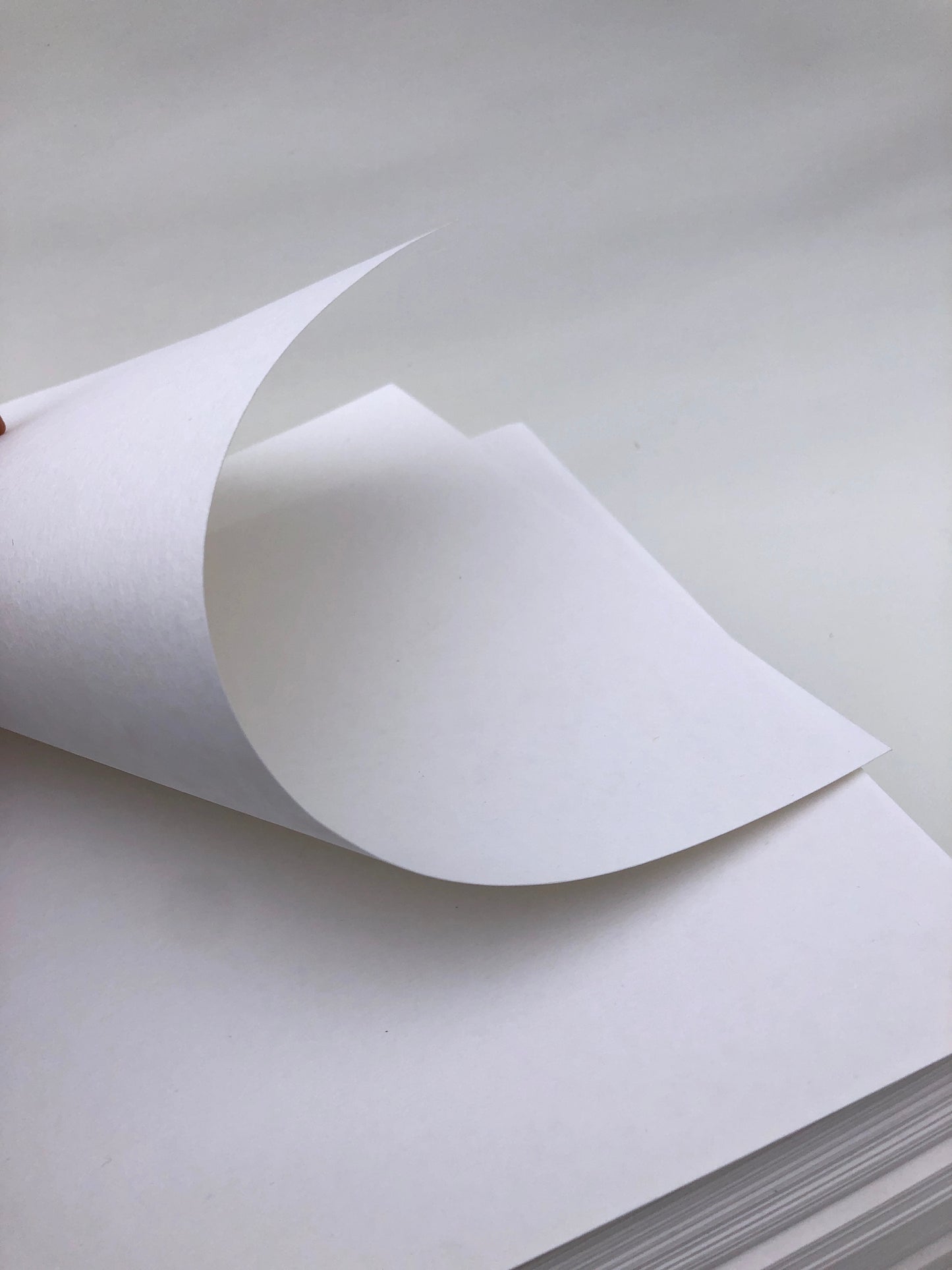 Partially bended white paper, texture visible