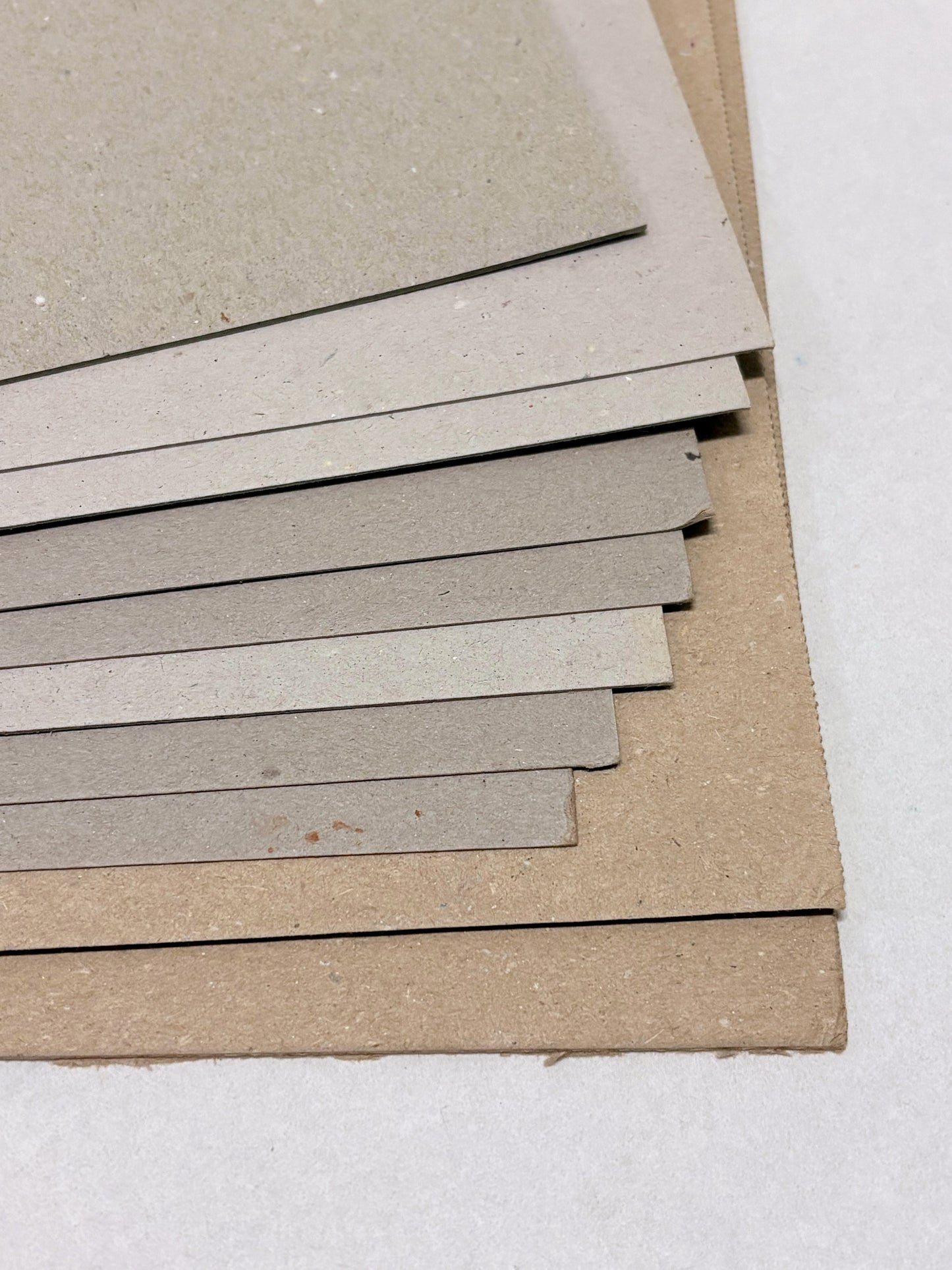 Close-up of a stack of thick sheets of various thickness and colours