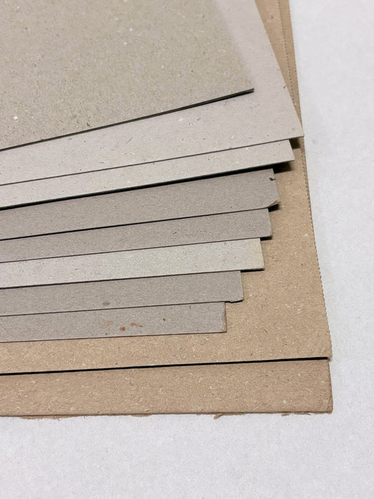 Close-up of a stack of thick sheets of various thickness and colours