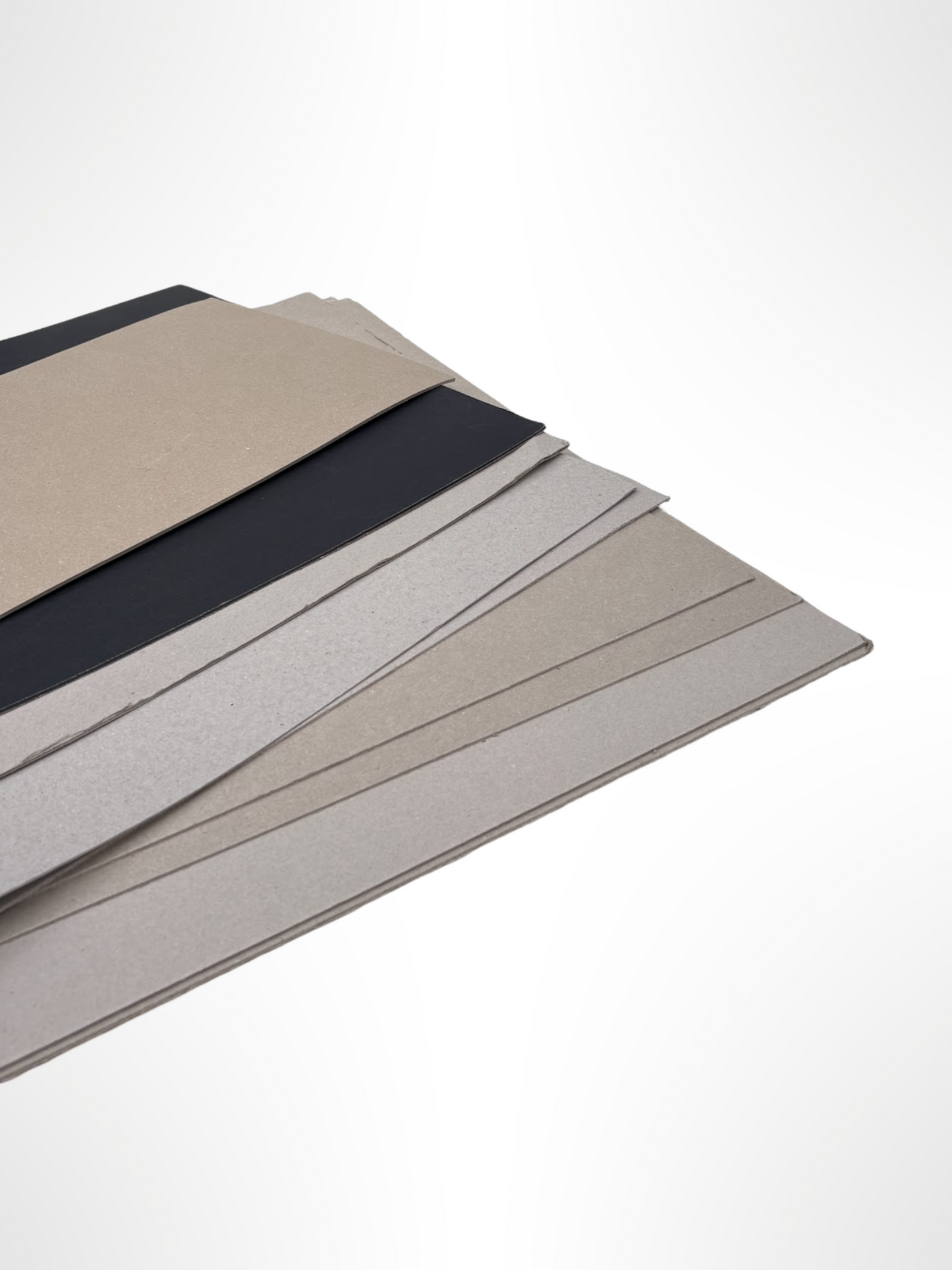 A stack of thick sheets of various sizes, thickness, and colours
