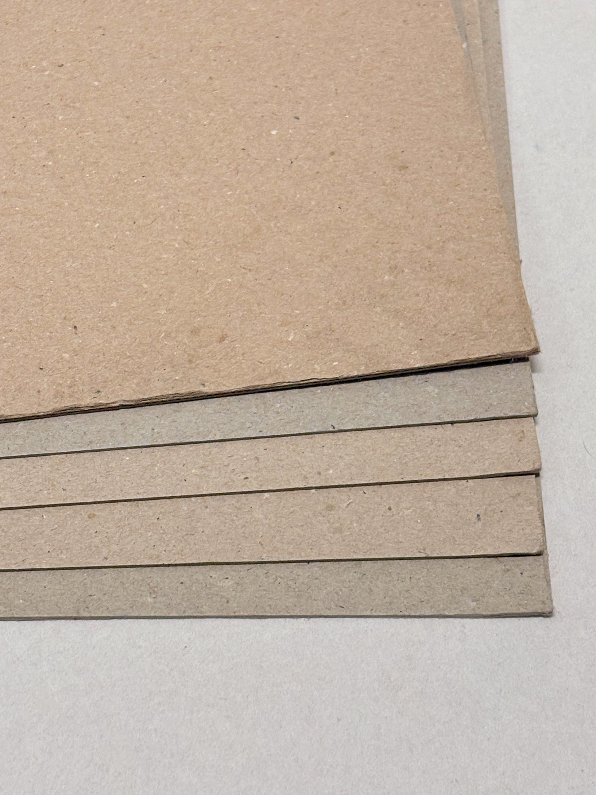 Close-up of a stack of thick sheets of various thickness and colours