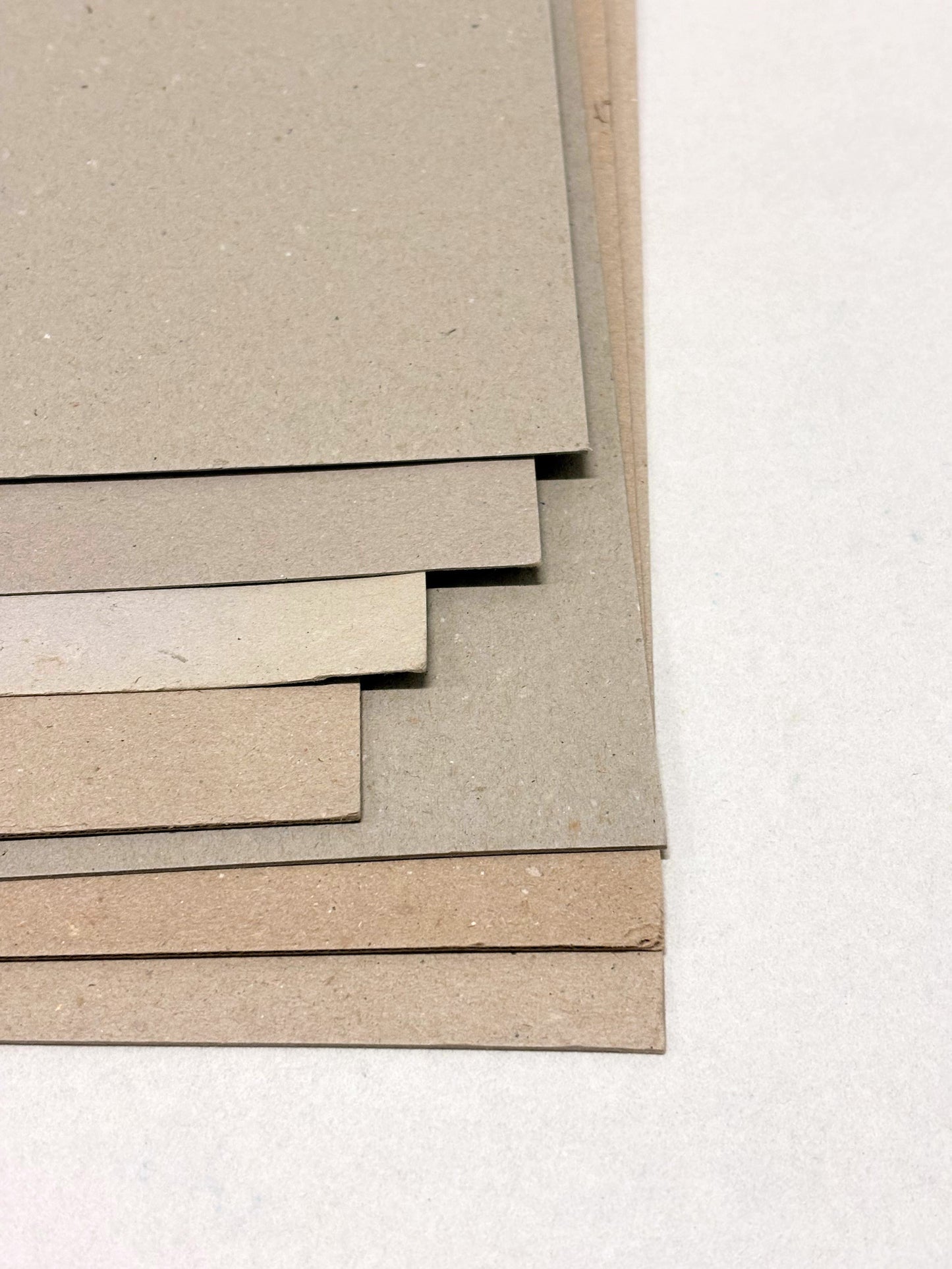 Close-up of a stack of thick sheets of various thickness and colours