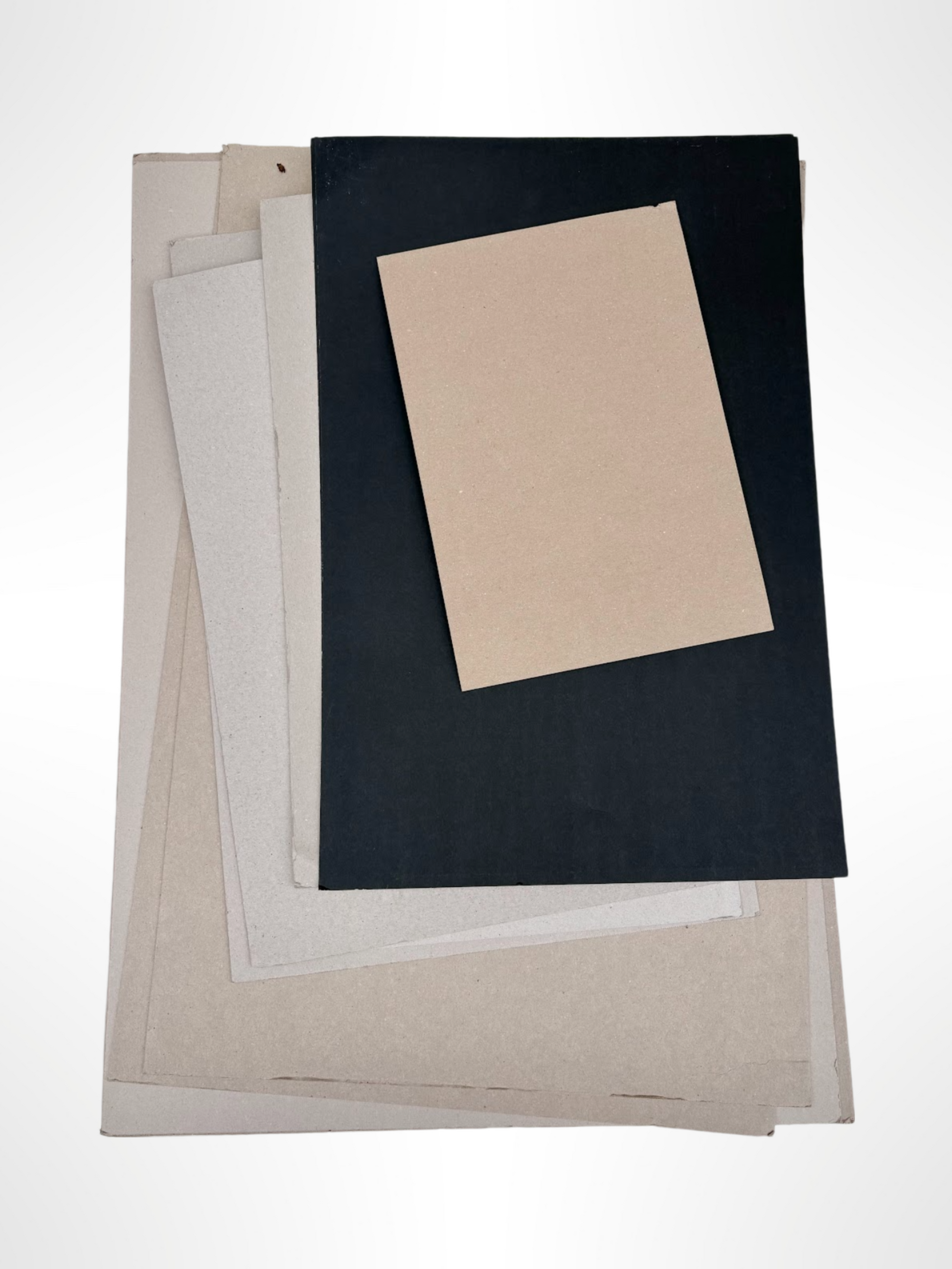 A stack of thick sheets of various sizes and colours