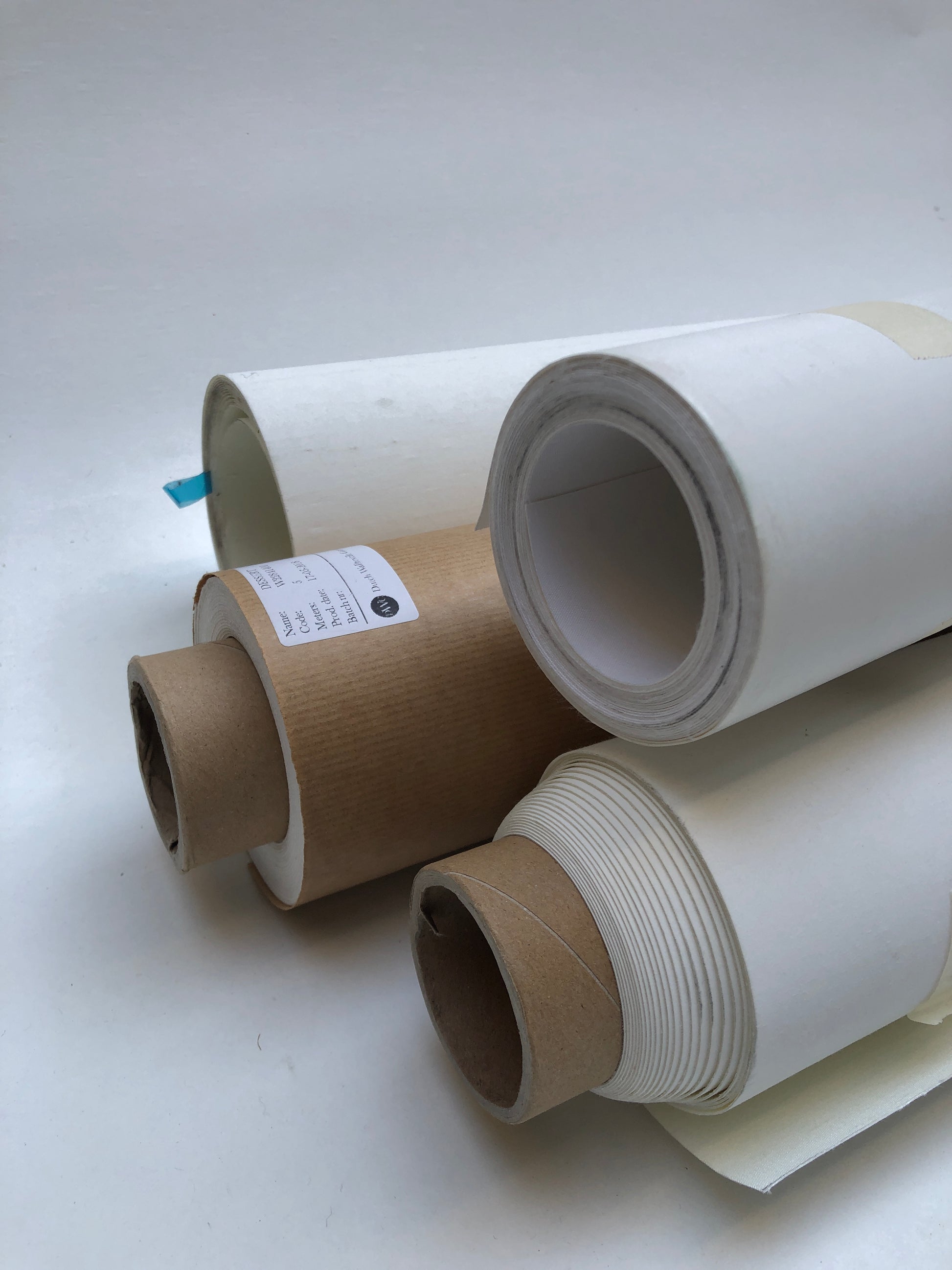 Close-up of collection of rolled white canvas papers