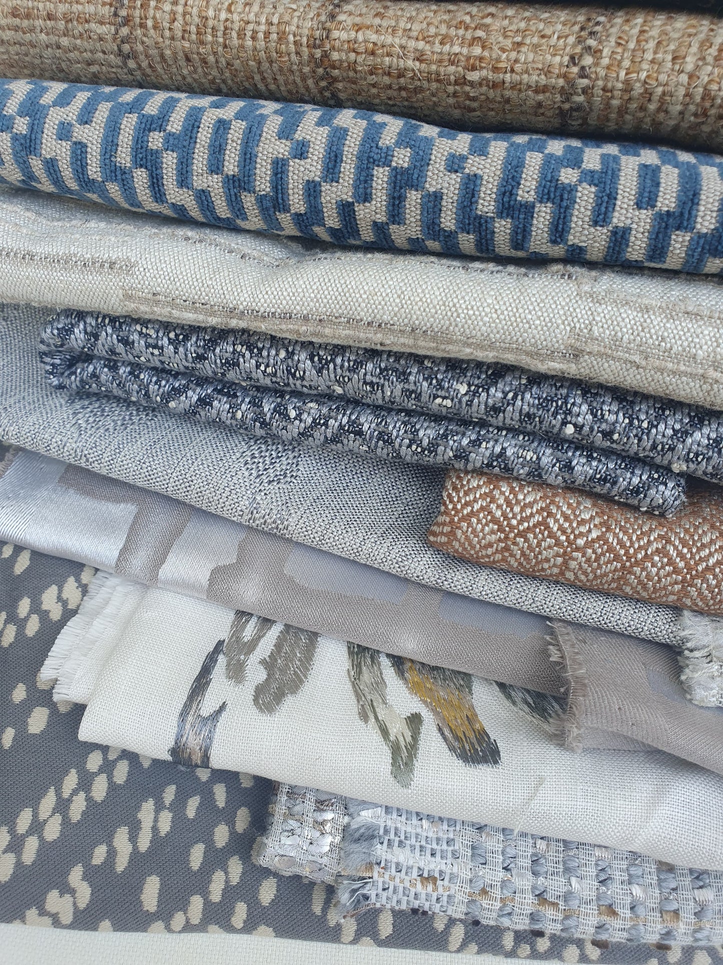 Close-up of a stack of patterned fabric with various colours 