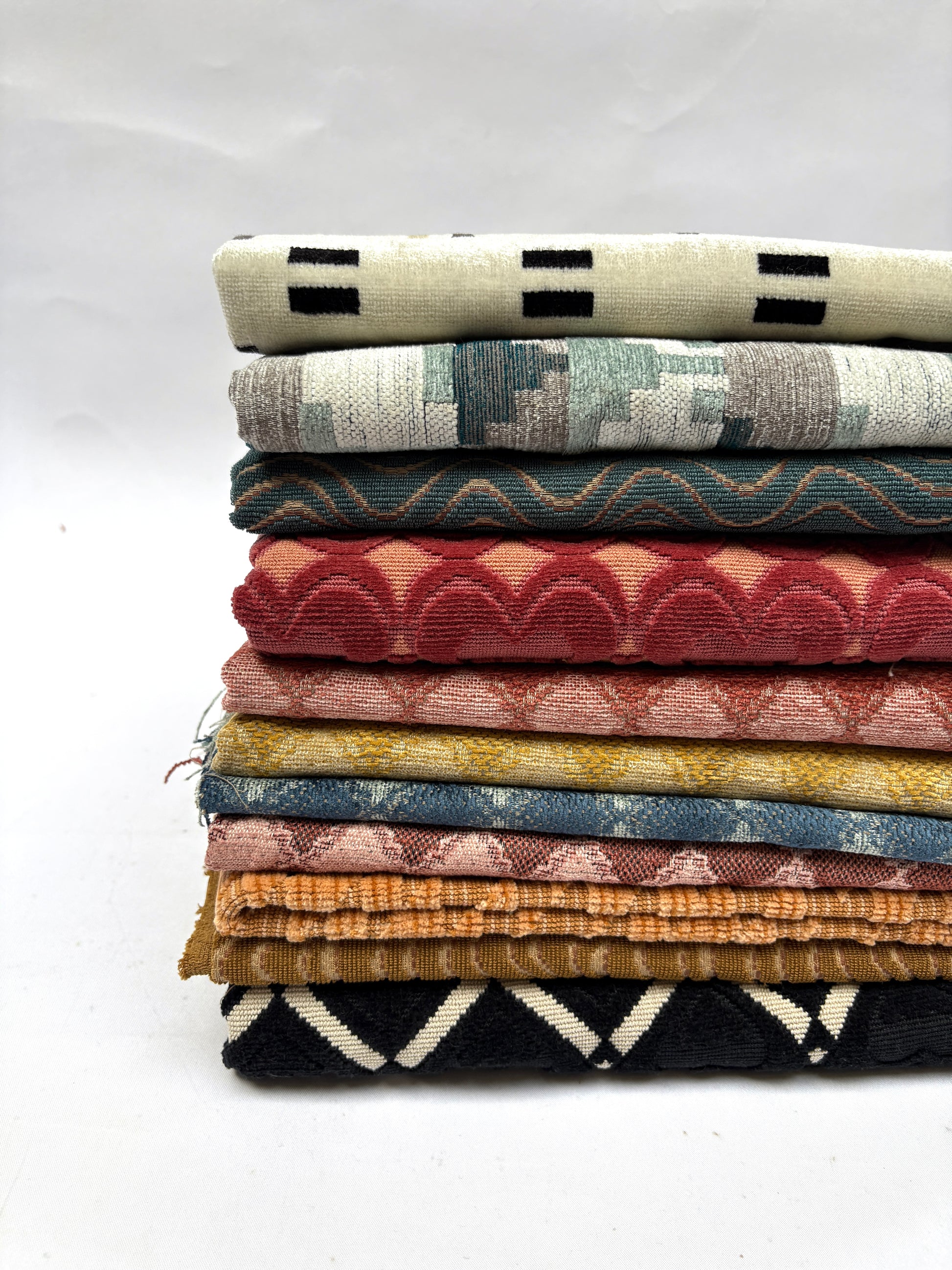 Stack of patterned fabric in various colours 