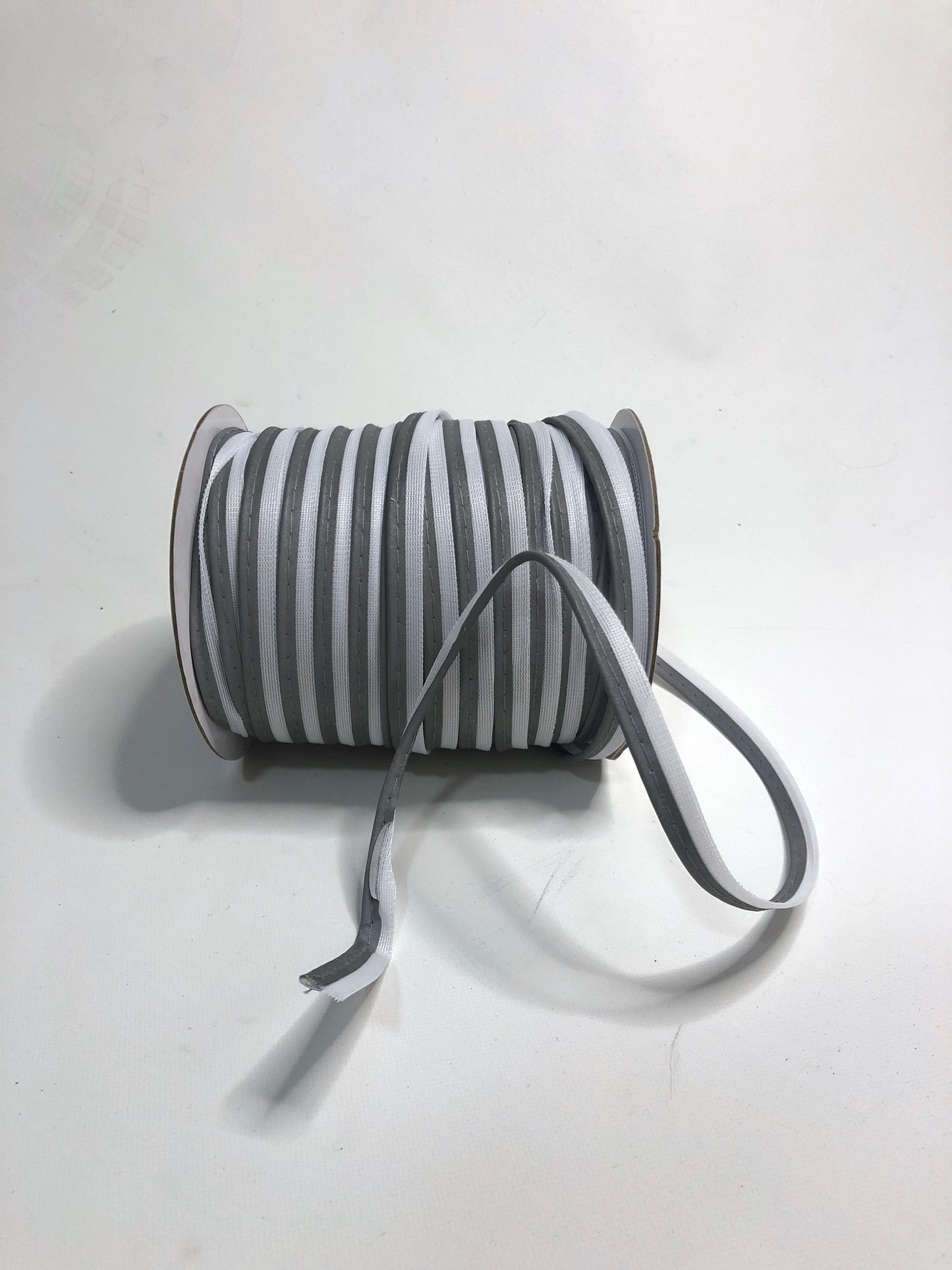 A roll of silver reflective piping tape 