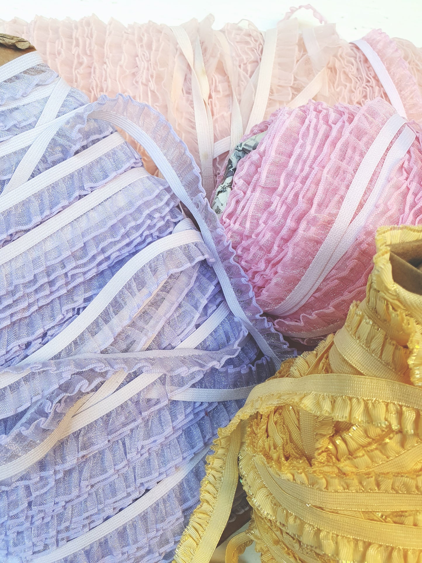 Close-up of the 4 different pastel coloured piping trim laces