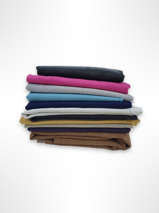 A stack of various coloured fabrics 