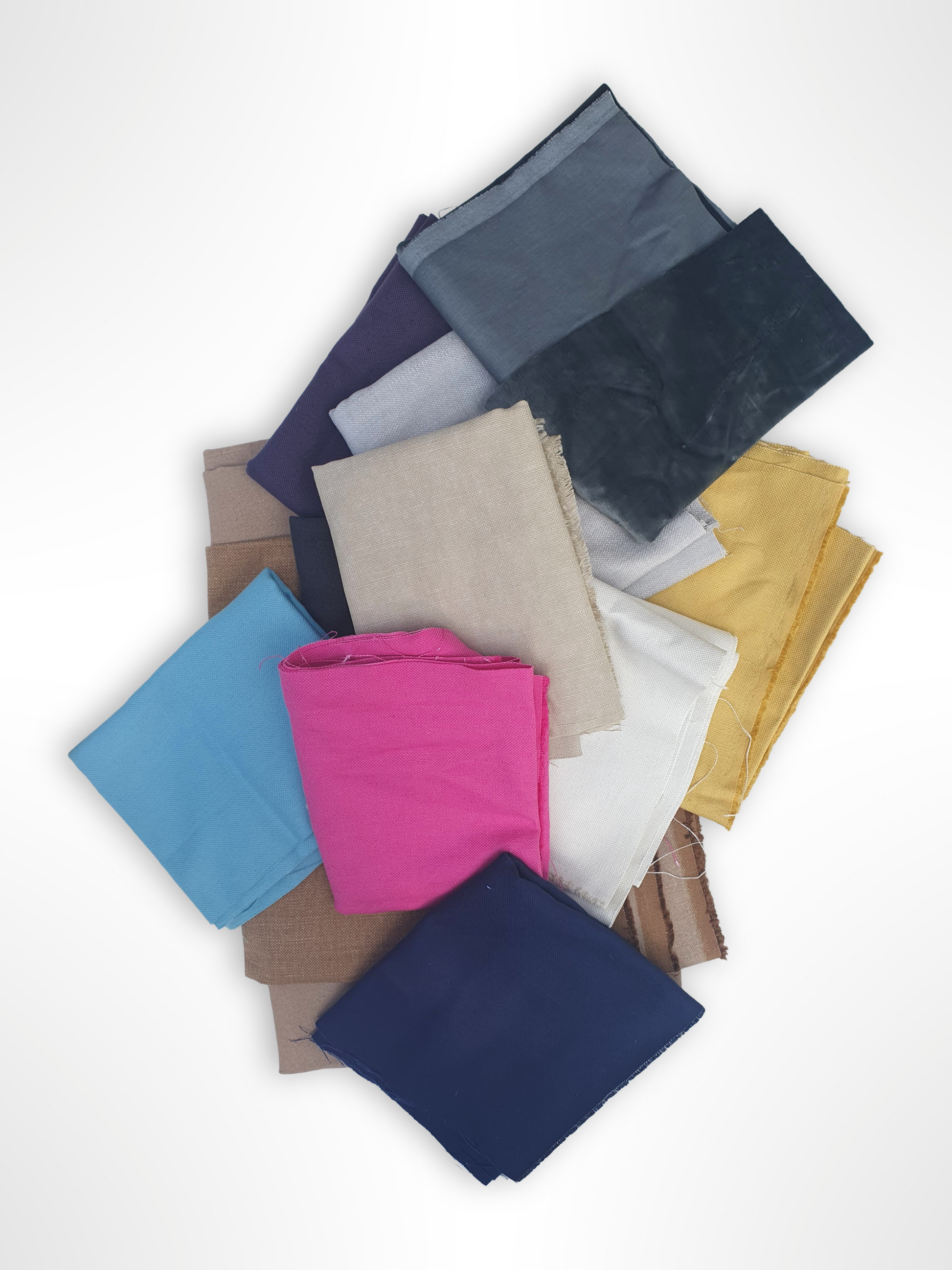 Collection of folded various coloured plain fabrics