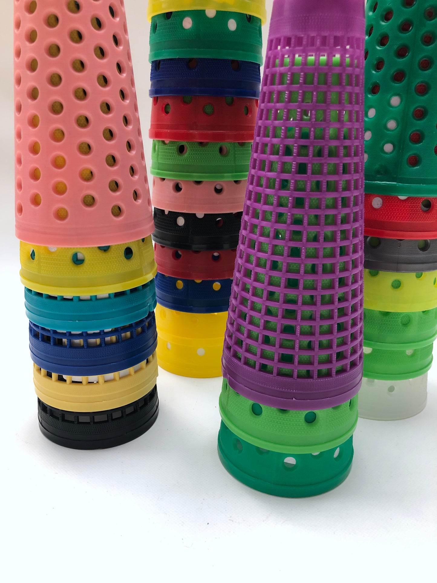Close-up of a collection of colourful plastic cones with small dotted holes