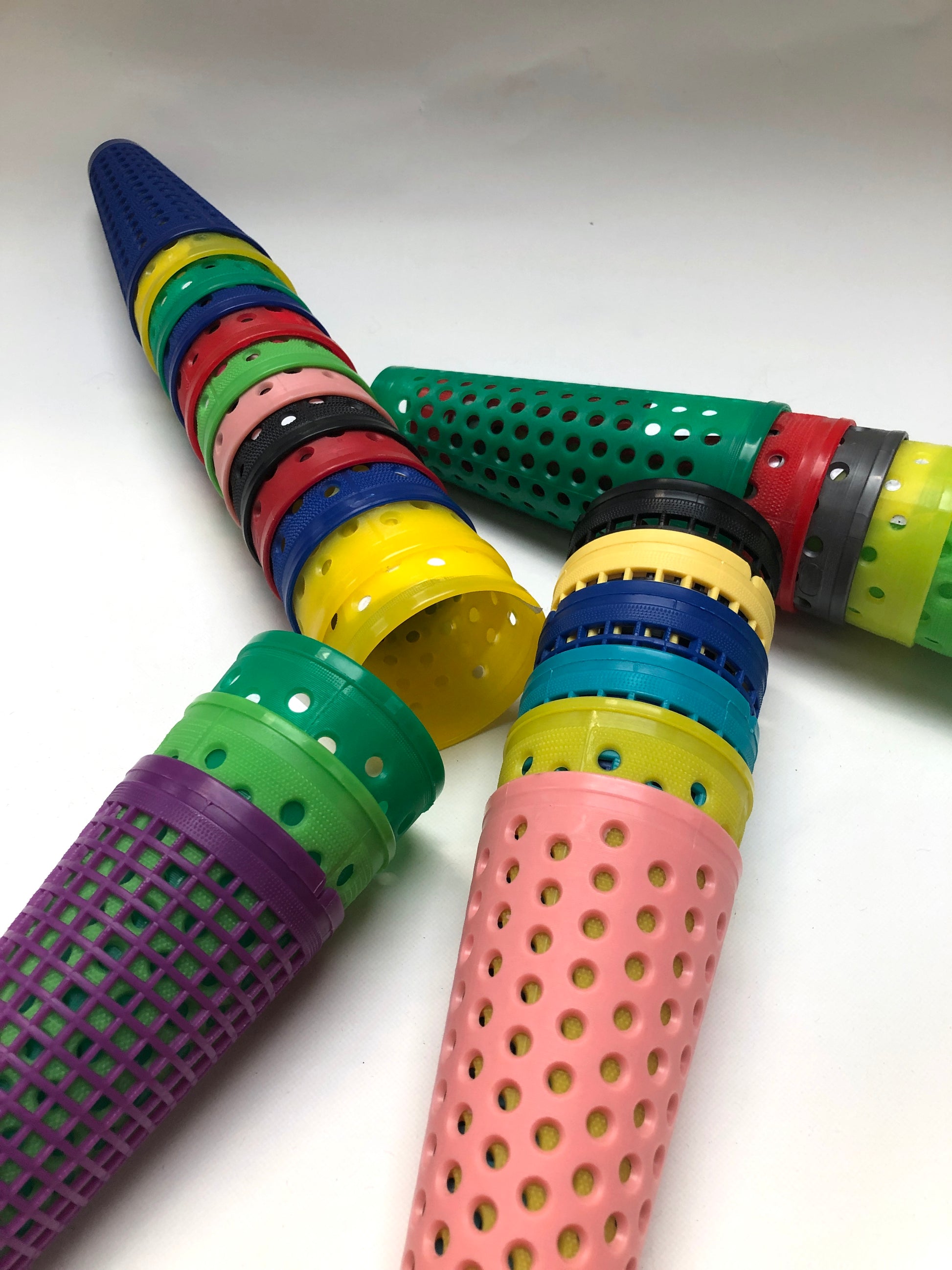 A collection of colourful plastic cones with small dotted holes