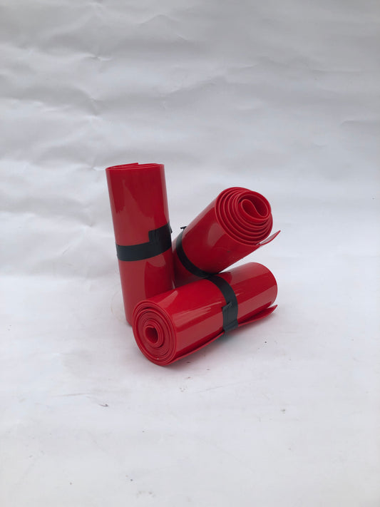3 rolled up red plastic strips curtain