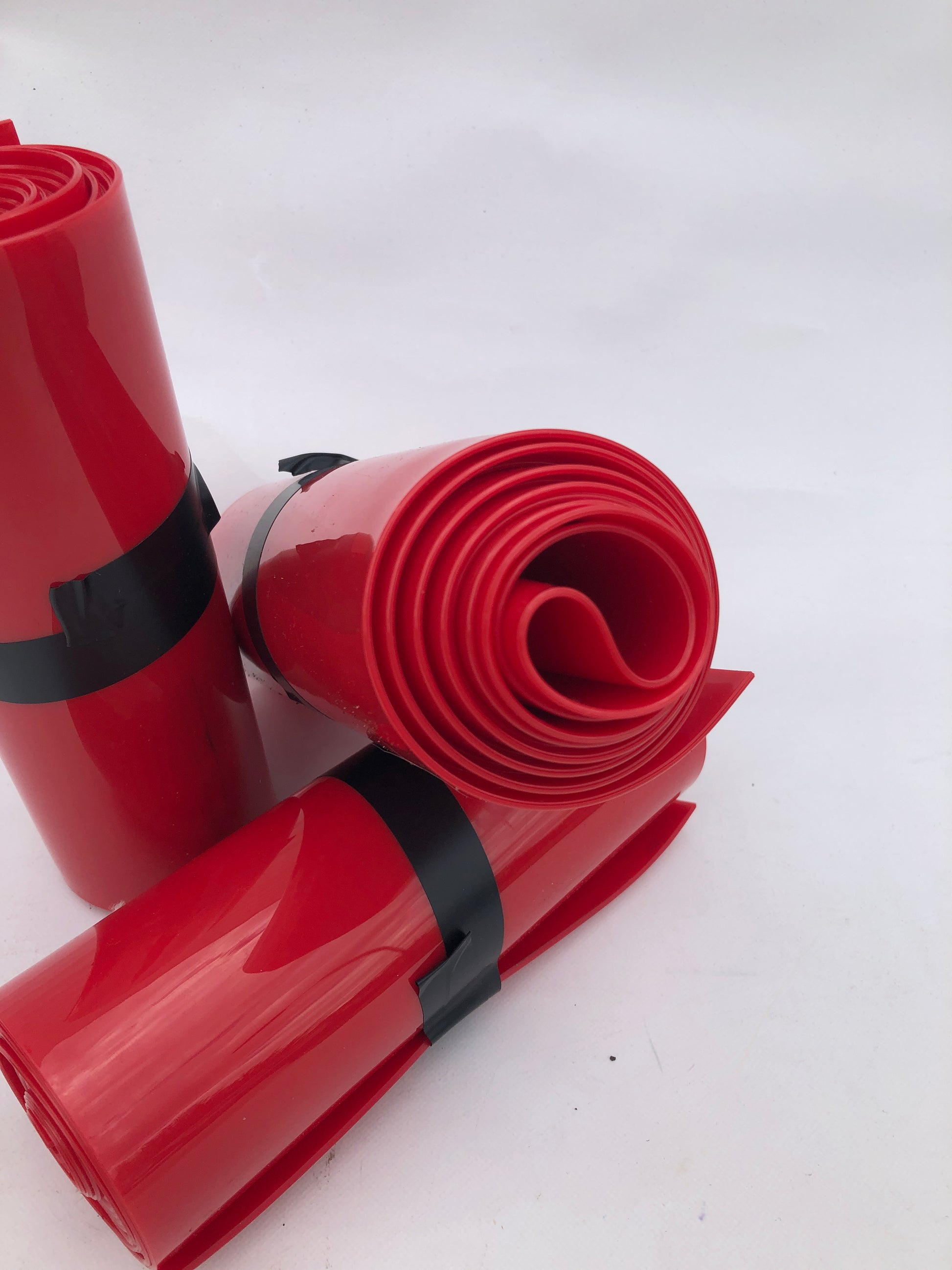 Close-up of 3 rolled up red plastic strips curtain
