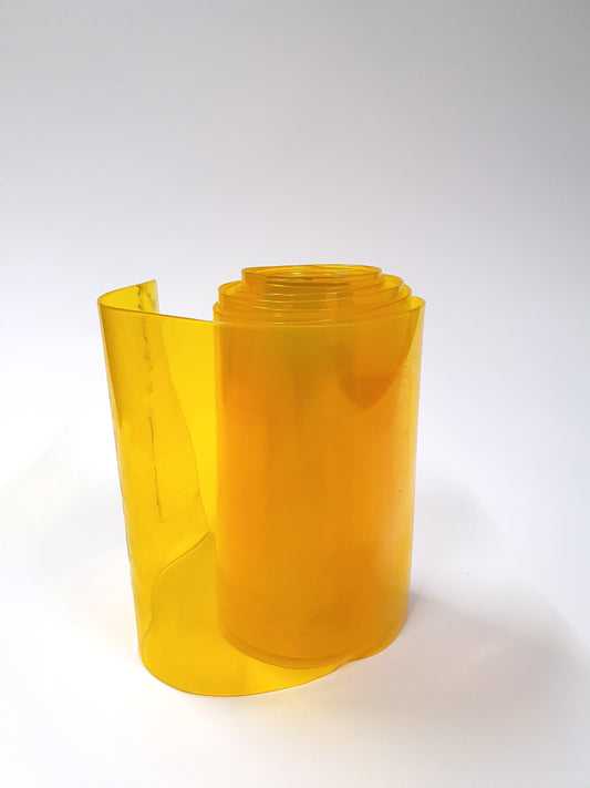 A rolled up yellow PVC strip curtain 