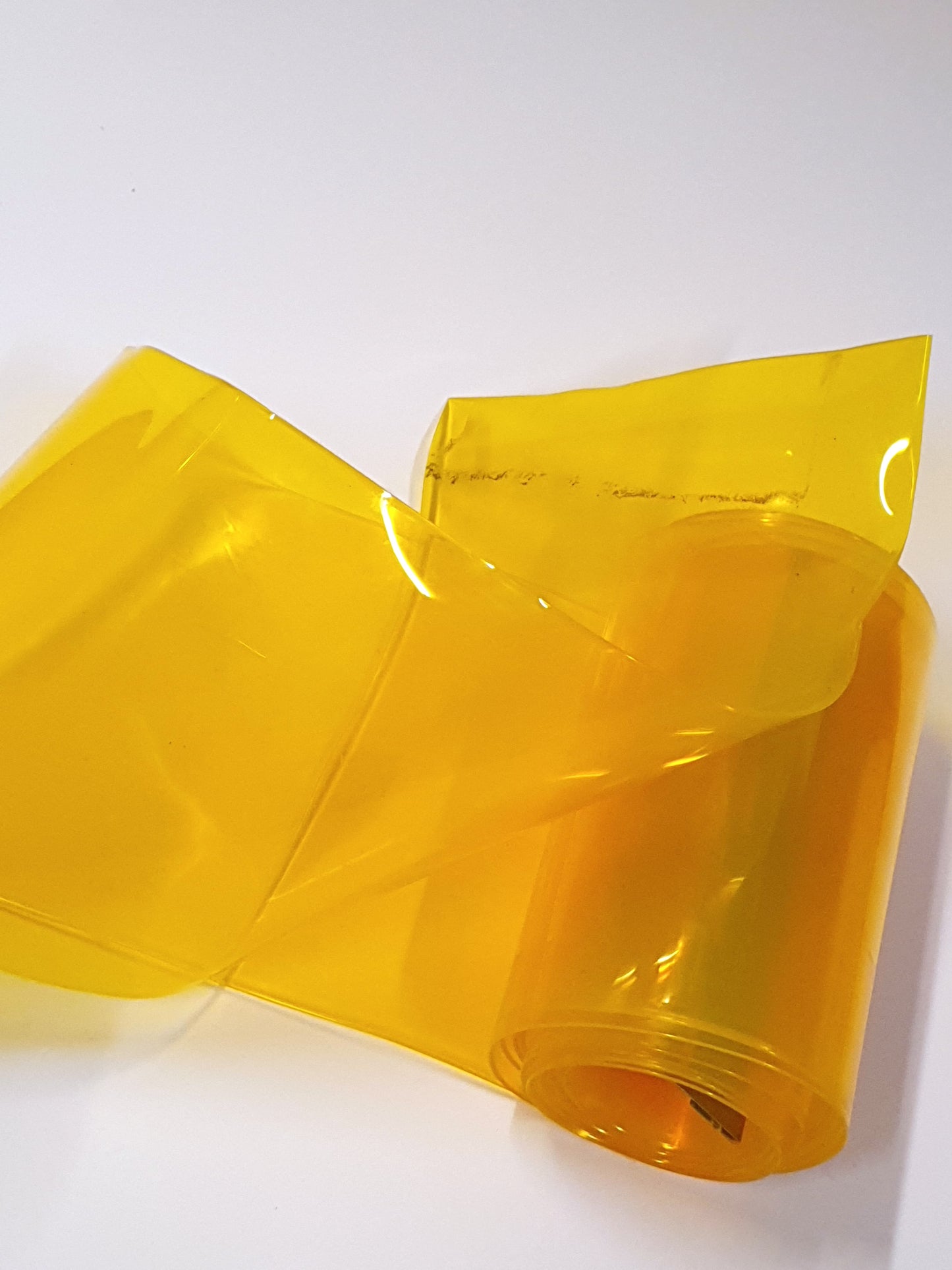 Partially unfolded yellow PVC strip curtain.