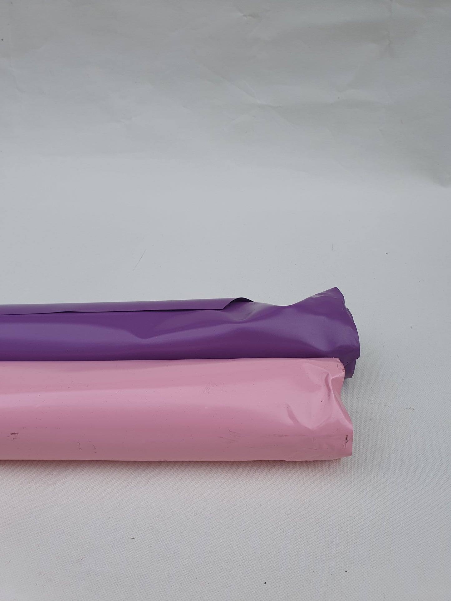 2 rolls of pink and purple shiny plastic films