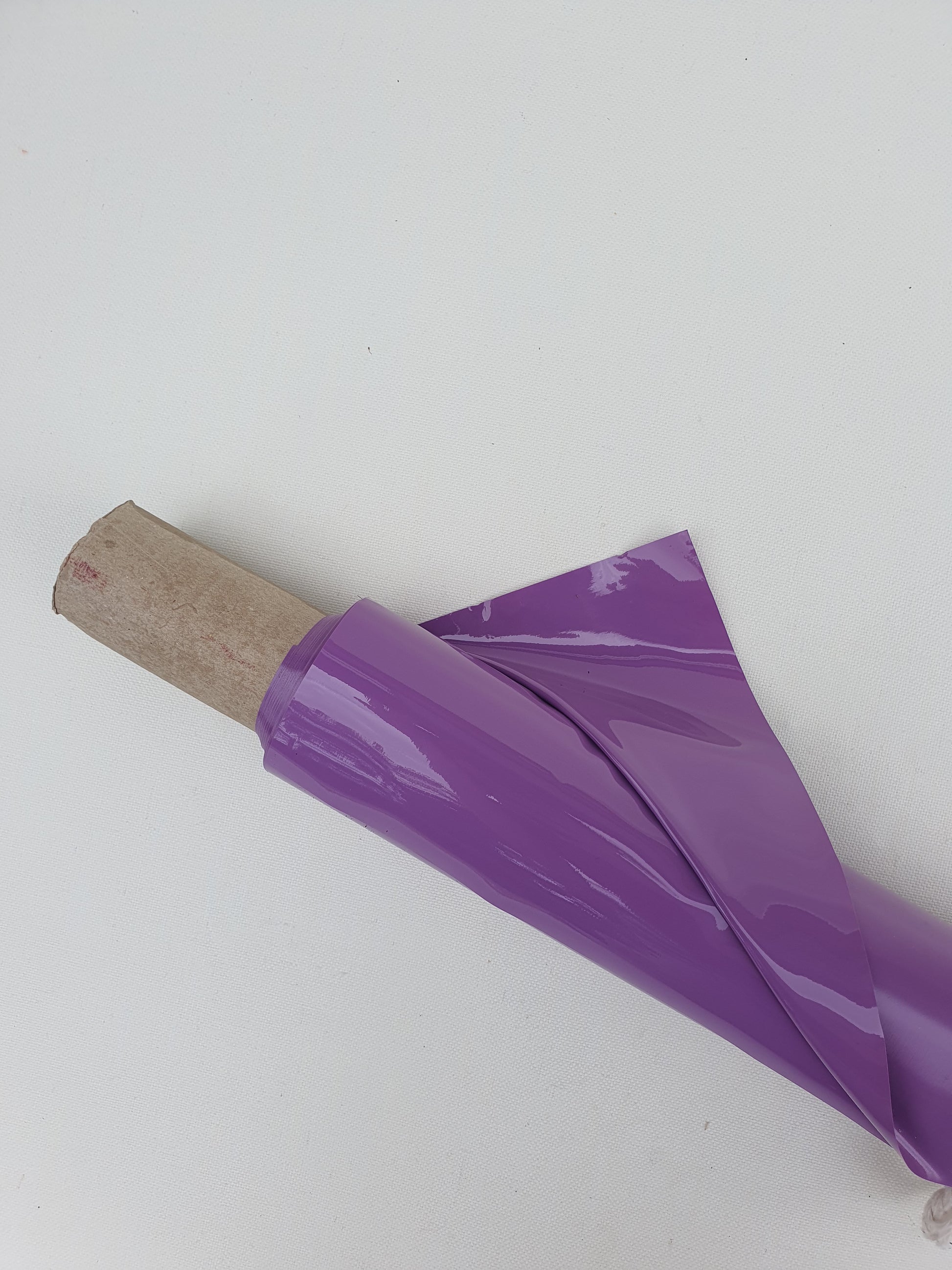 Close-up of a purple rolled-up shiny plastic film