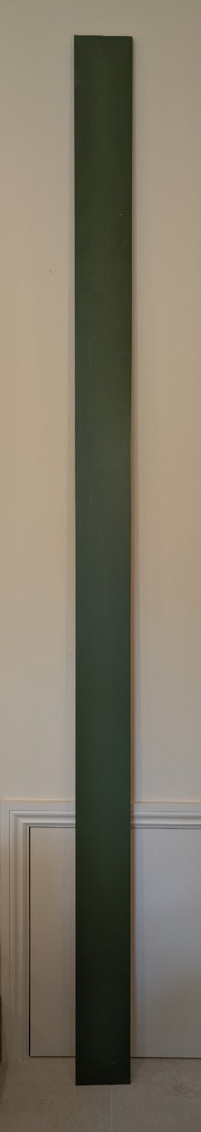 A green-painted, long and narrow vertically pine plinth 