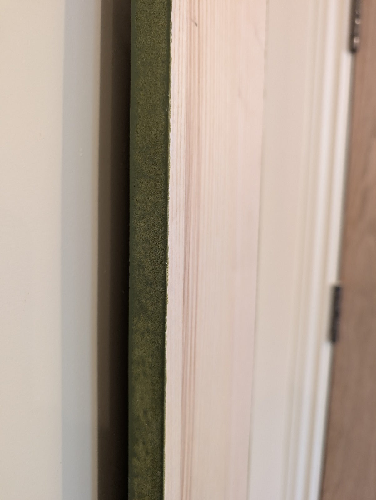 Close-up of green pine plinth from its side