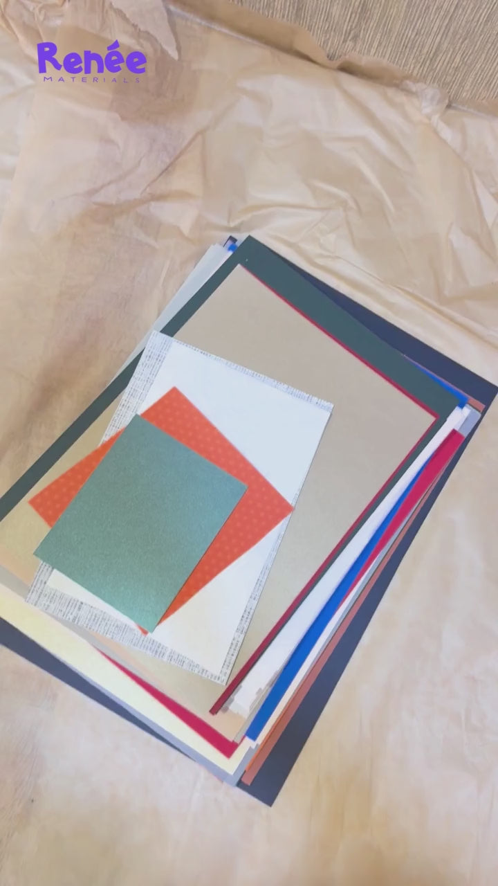 someone filming themselves going through a stack of coloured paper