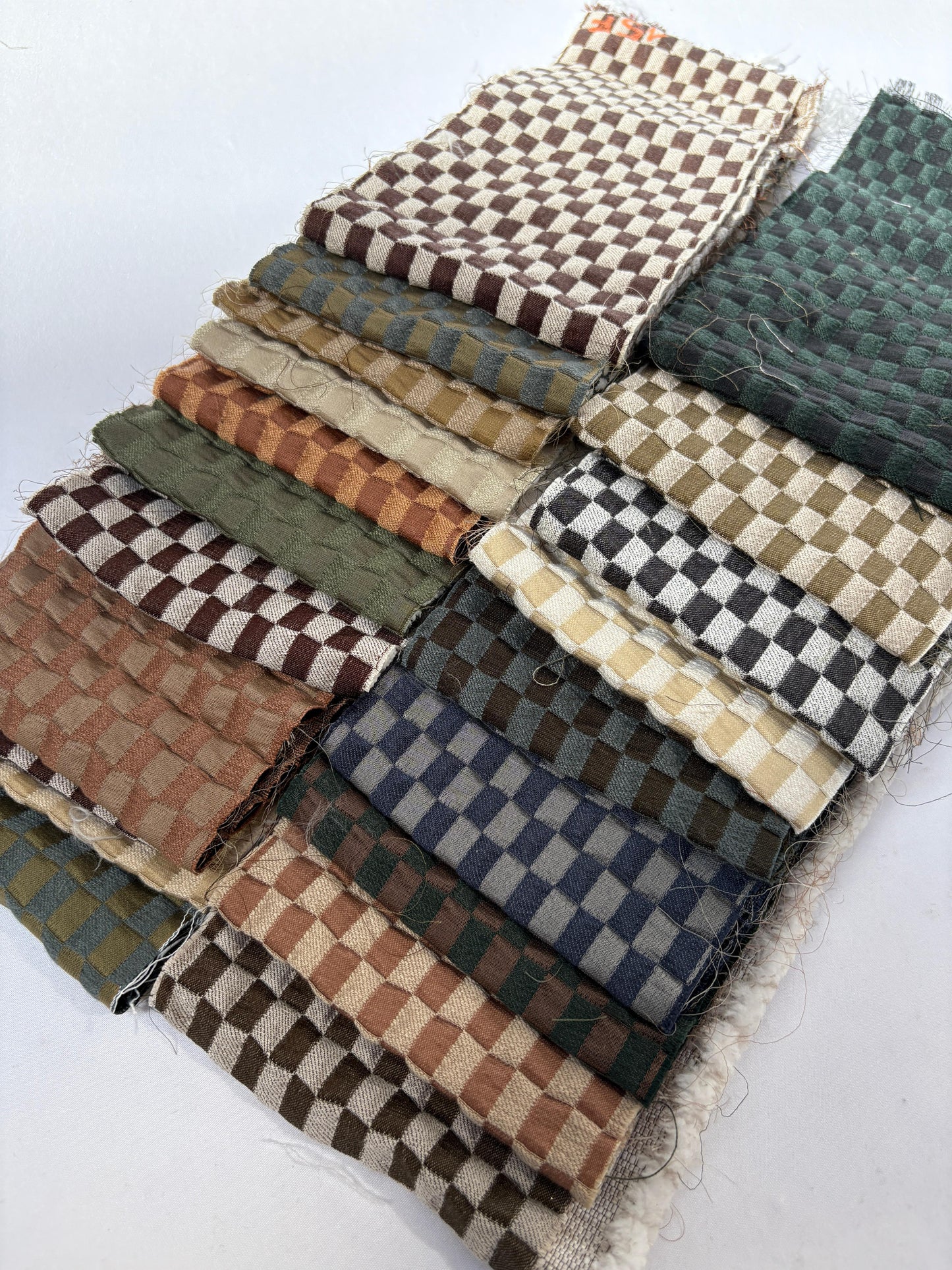 2 stacks of checkered quilted fabric offcuts in various colours