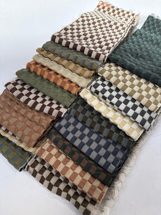 2 stacks of checkered quilted fabric offcuts in various colours